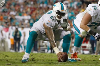 Nov 11, 2013; Tampa, FL, USA; Miami Dolphins center Mike Pouncey (51) gets ready to hike the ball against the Tampa Bay Lightning during the first half at Raymond James Stadium. Mandatory Credit: Kim Klement-USA TODAY Sports
