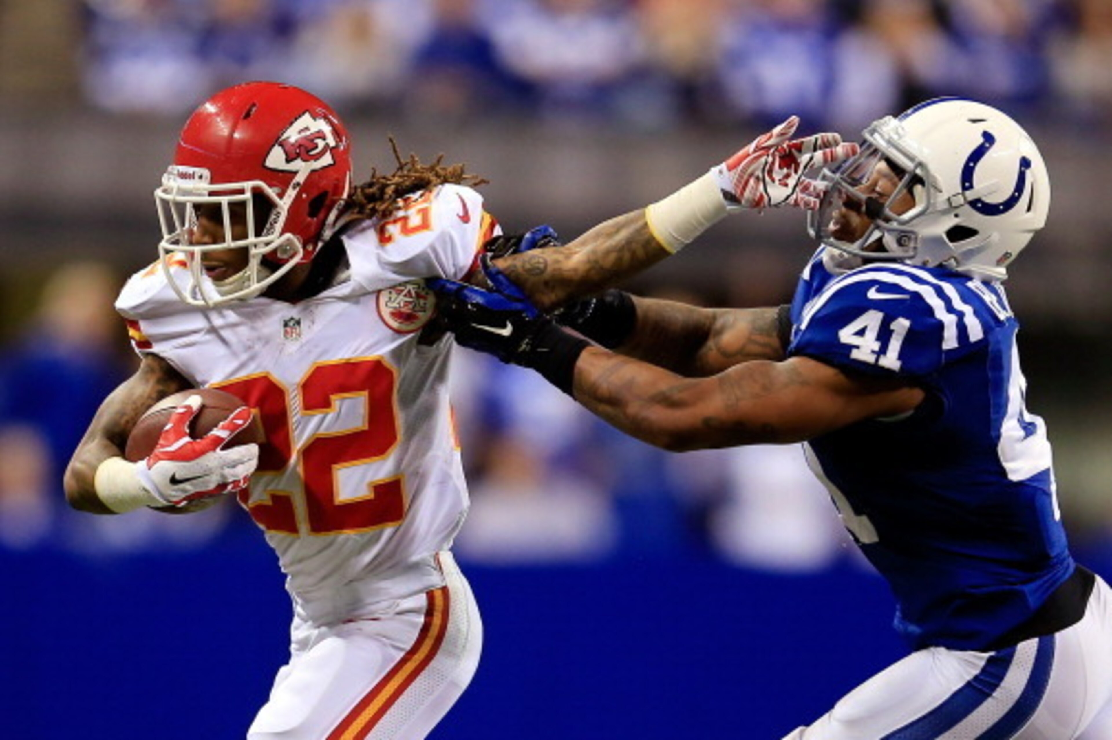 INDIANAPOLIS, IN - JANUARY 04: Wide receiver Dexter McCluster #22 of the Kansas City Chiefs carries the ball as strong safety Antoine Bethea #41 of the Indianapolis Colts defends during a Wild Card Playoff game at Lucas Oil Stadium on January 4, 2014 in INDIANAPOLIS, IN - JANUARY 04: Wide receiver Dexter McCluster #22 of the Kansas City Chiefs carries the ball as strong safety Antoine Bethea #41 of the Indianapolis Colts defends during a Wild Card Playoff game at Lucas Oil Stadium on January 4, 2014 in