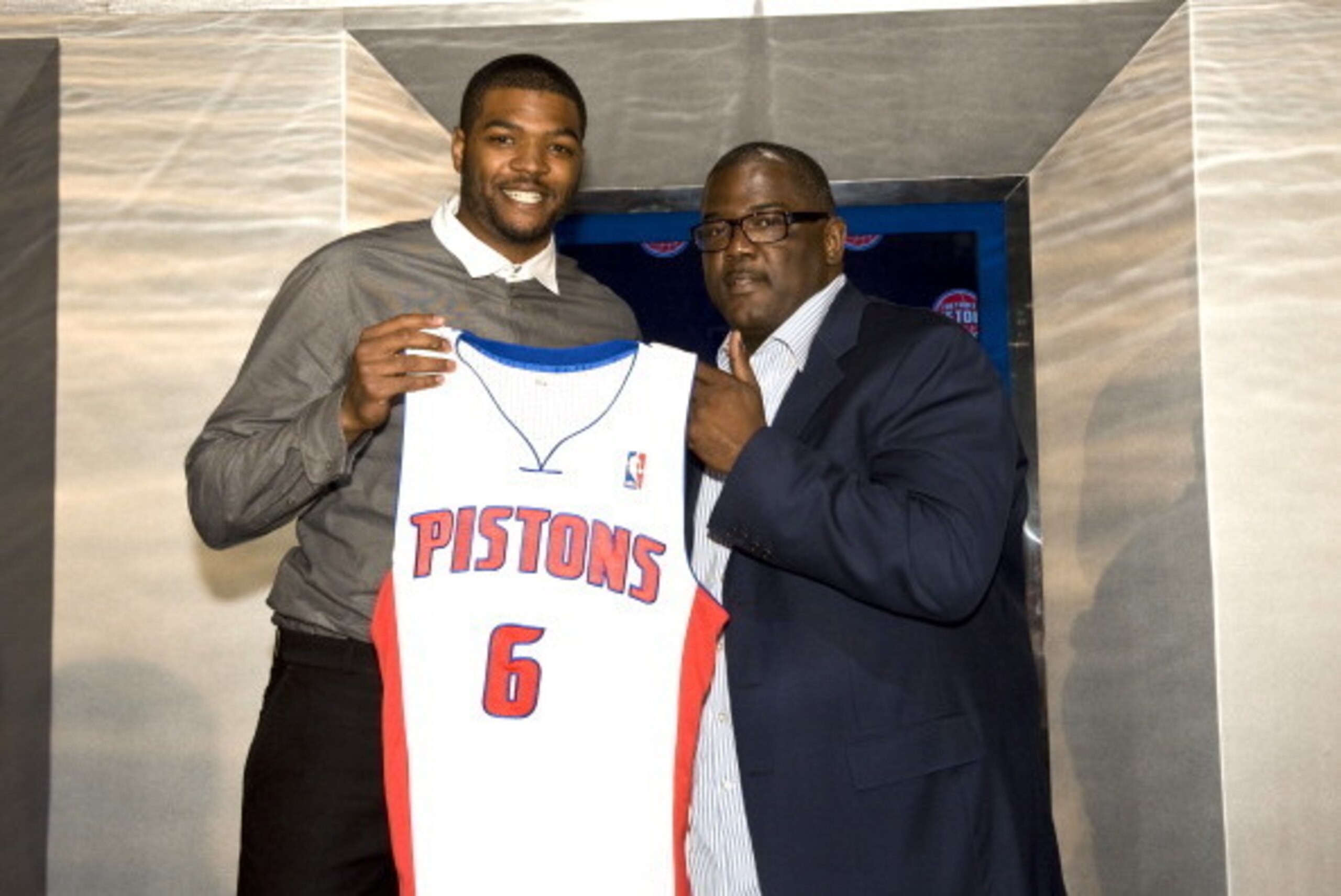 AUBURN HILLS - JULY 10:  Joe Dumars, President of Basketball Operations (R) poses with new Detroit Piston, Josh Smith and his new jersey at a press conference on July 10, 2013 at Palace of Auburn Hills in Auburn Hills, Michigan. NOTE TO USER: User express