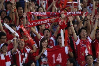 HANOI, VIETNAM - JULY 17:  Vietnamese Arsenal fans show their support during the international friendly match between Vietnam and Arsenal FC at My Dinh National Stadium on July 17, 2013 in Hanoi, Vietnam.  (Photo by Chris McGrath/Getty Images)