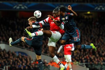LONDON, ENGLAND - FEBRUARY 19:  Yaya Sanogo of Arsenal is marshalled by Toni Kroos and David Alaba of Bayern Muenchen during the UEFA Champions League Round of 16 first leg match between Arsenal and FC Bayern Muenchen at Emirates Stadium on February 19, 2