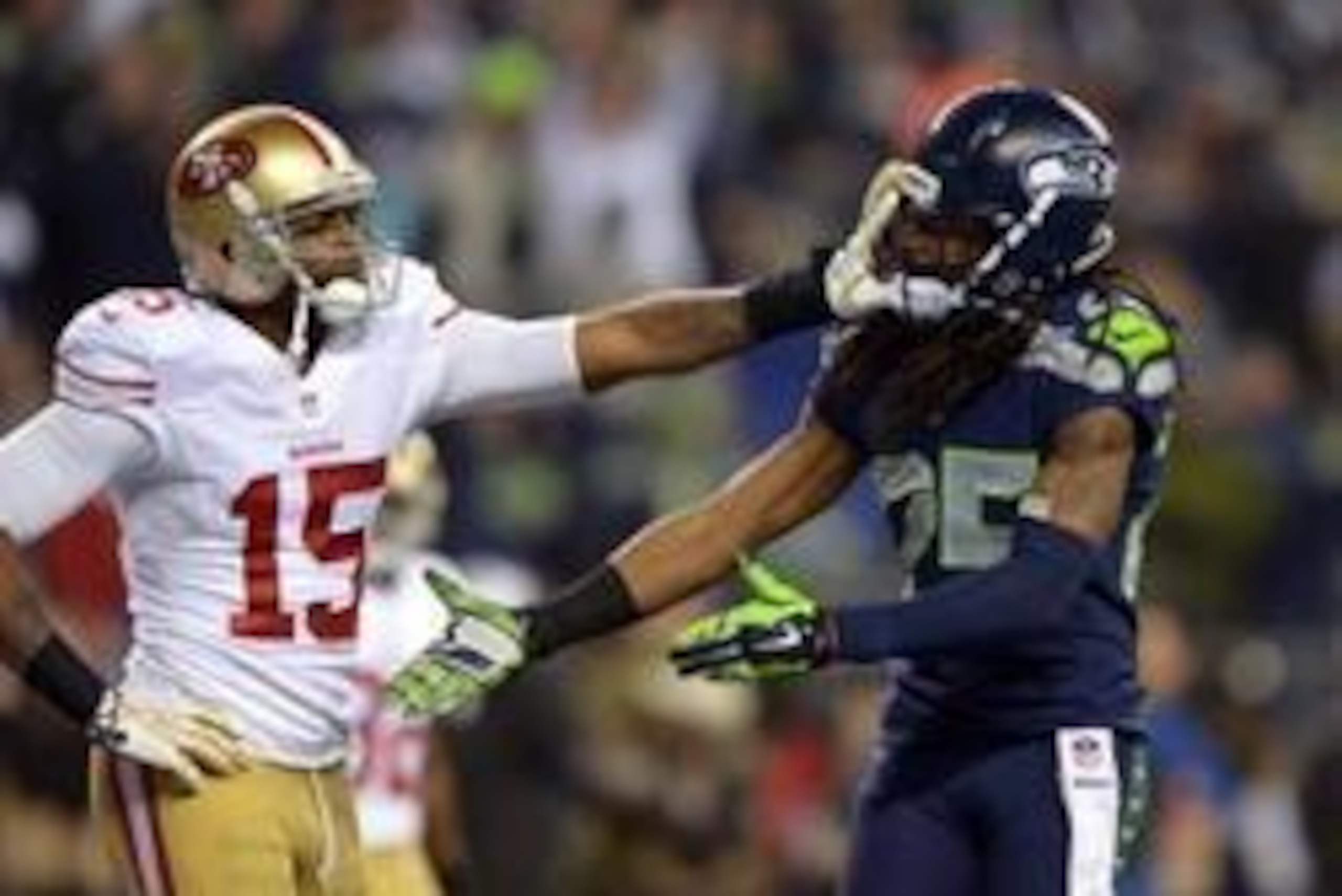 Jan 19, 2014; Seattle, WA, USA; Seattle Seahawks cornerback Richard Sherman (25) gets shoved in the face by San Francisco 49ers wide receiver Michael Crabtree (15) while trying to shake hands after an interception by Seahawks outside linebacker Malcolm Sm