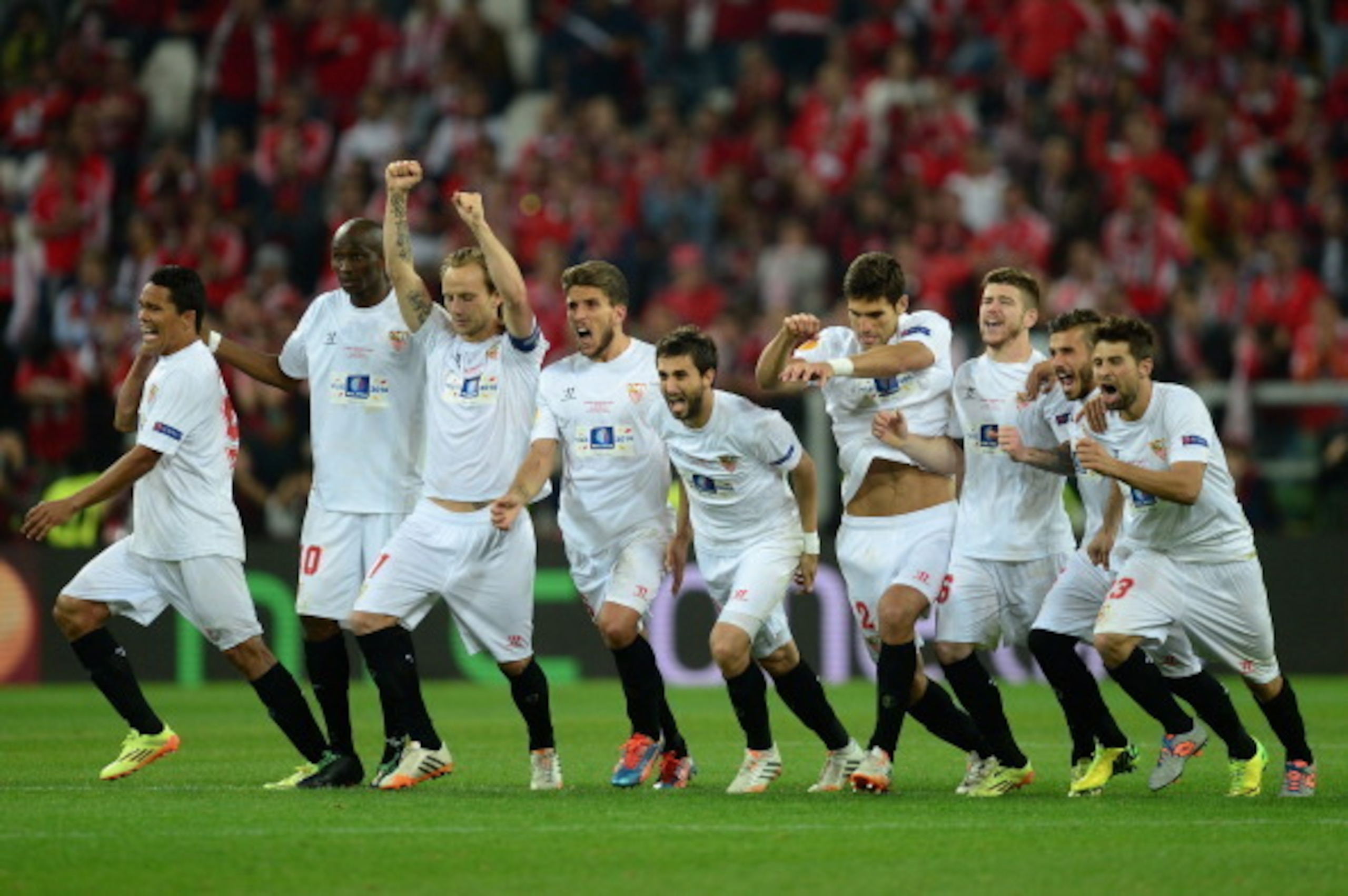 TURIN, ITALY - MAY 14: Sevilla players celebrate after Kevin Gameiro of Sevilla (not pictured) scores the winning penalty in the shoot out during the UEFA Europa League Final match between Sevilla FC and SL Benfica at Juventus Stadium on May 14, 2014 in T TURIN, ITALY - MAY 14: Sevilla players celebrate after Kevin Gameiro of Sevilla (not pictured) scores the winning penalty in the shoot out during the UEFA Europa League Final match between Sevilla FC and SL Benfica at Juventus Stadium on May 14, 2014 in T