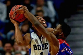 CHICAGO, IL - NOVEMBER 12: Jabari Parker #1 of the Duke Blue Devils tries to shoot against Andrew Wiggins #22 of the Kansas Jayhawks during the State Farm Champions Classic at the United Center on November 12, 2013 in Chicago, Illinois. Kansas defeated Du