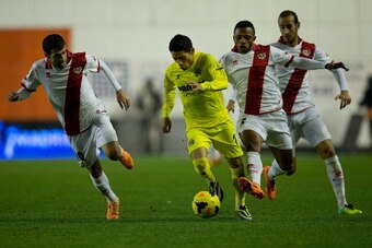 MADRID, SPAIN - JANUARY 06: Javier Ignacio Aquino (2nd L) of Villarreal CF competes for the ball with Alhassane Bangoura alias Lass (2nd R) of Rayo Vallecano de Madrid and his teammates Roberto Tashorras (L) and Alejandro Galvez (R) during the La Liga mat