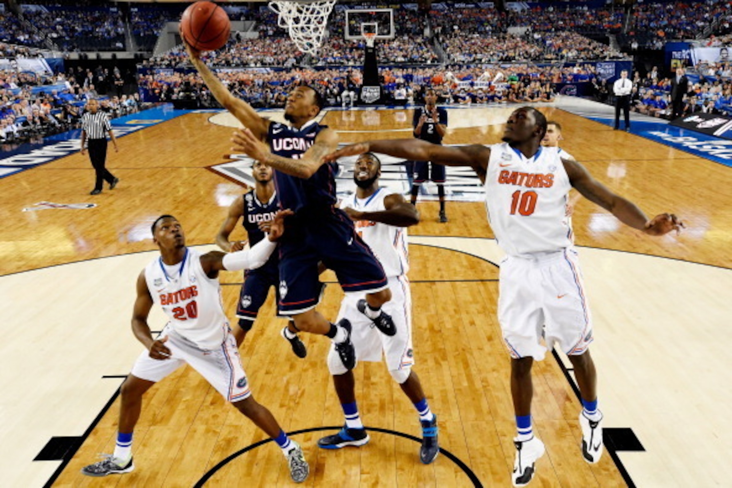 ARLINGTON, TX - APRIL 05: Shabazz Napier #13 of the Connecticut Huskies goes up for a shot as Dorian Finney-Smith #10 of the Florida Gators defends during the NCAA Men's Final Four Semifinal at AT&T Stadium on April 5, 2014 in Arlington, Texas. (Photo by 