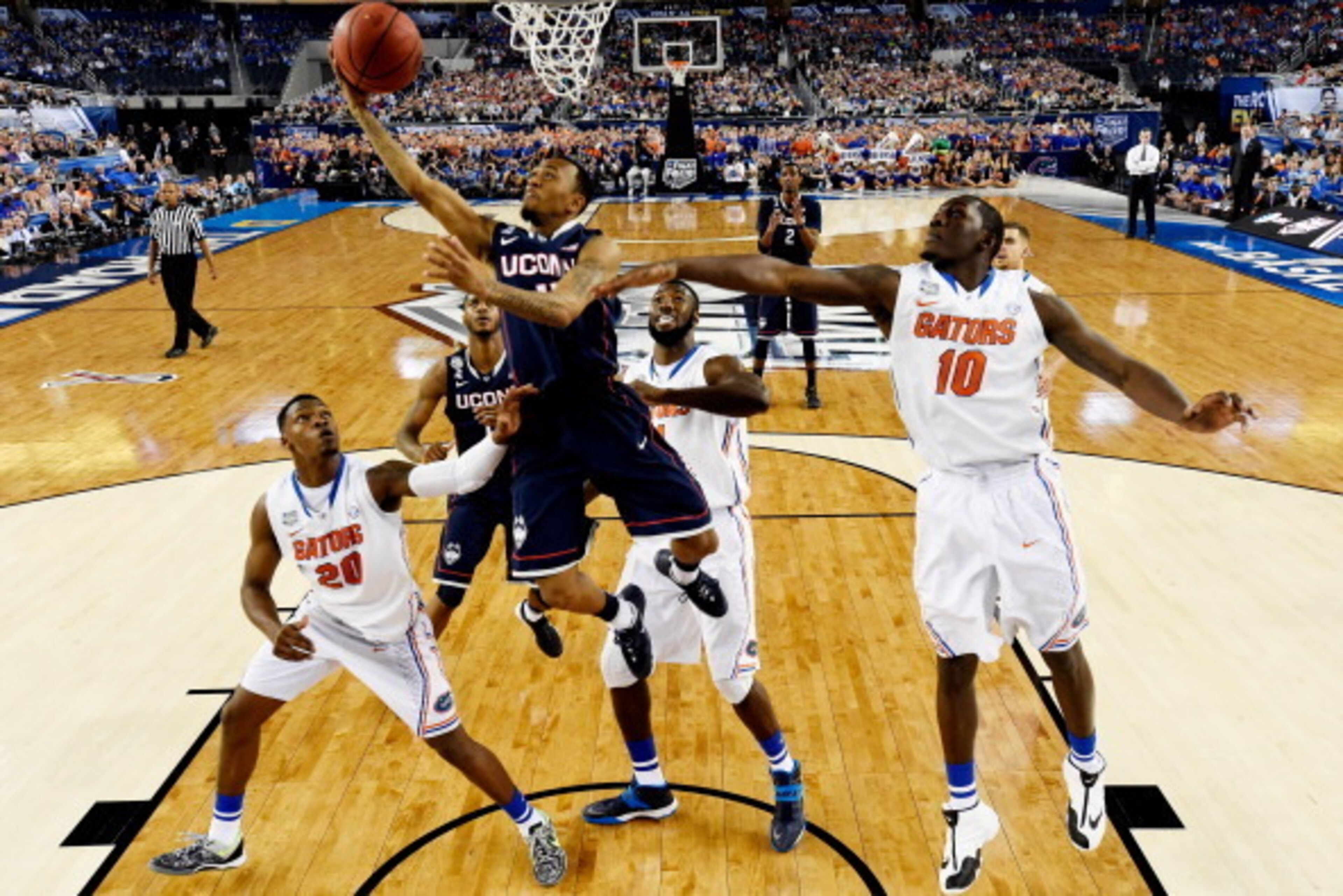 ARLINGTON, TX - APRIL 05: Shabazz Napier #13 of the Connecticut Huskies goes up for a shot as Dorian Finney-Smith #10 of the Florida Gators defends during the NCAA Men's Final Four Semifinal at AT&T Stadium on April 5, 2014 in Arlington, Texas. (Photo by 