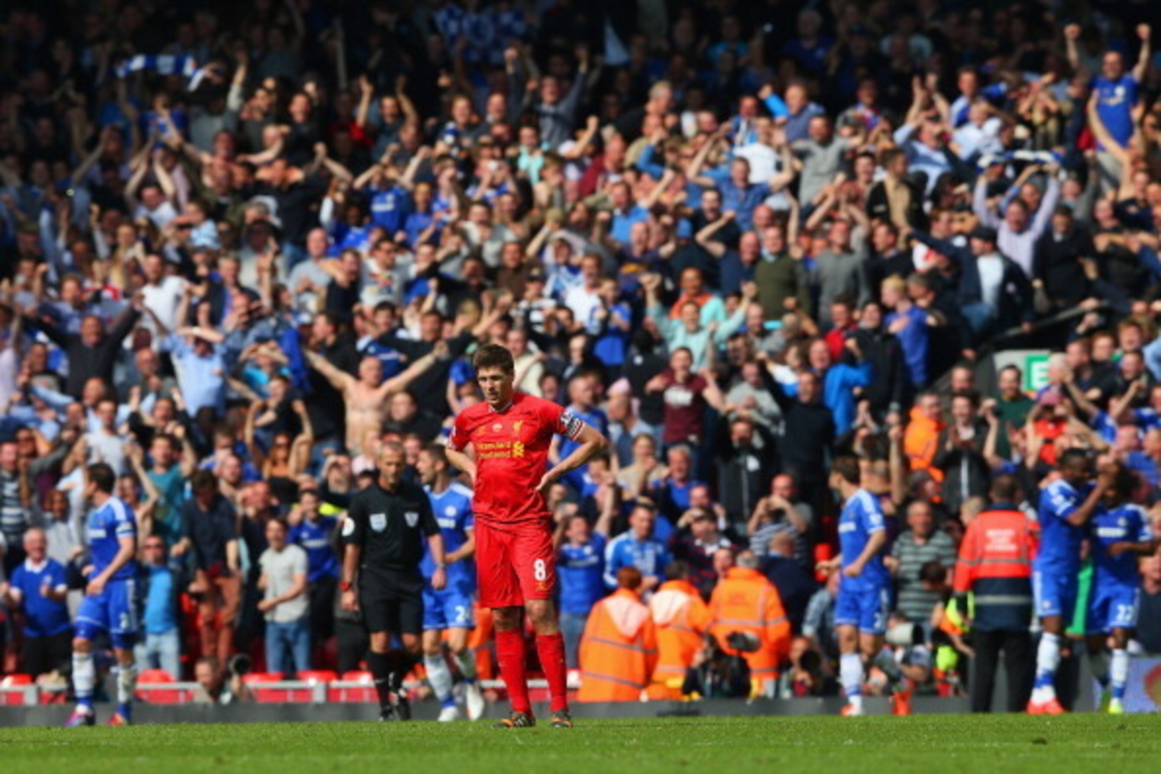LIVERPOOL, ENGLAND - APRIL 27: A dejected Steven Gerrard of Liverpool looks on as the Chelsea fans celebrate after Willian of Chelsea scored their second goal during the Barclays Premier League match between Liverpool and Chelsea at Anfield on April 27, LIVERPOOL, ENGLAND - APRIL 27: A dejected Steven Gerrard of Liverpool looks on as the Chelsea fans celebrate after Willian of Chelsea scored their second goal during the Barclays Premier League match between Liverpool and Chelsea at Anfield on April 27,