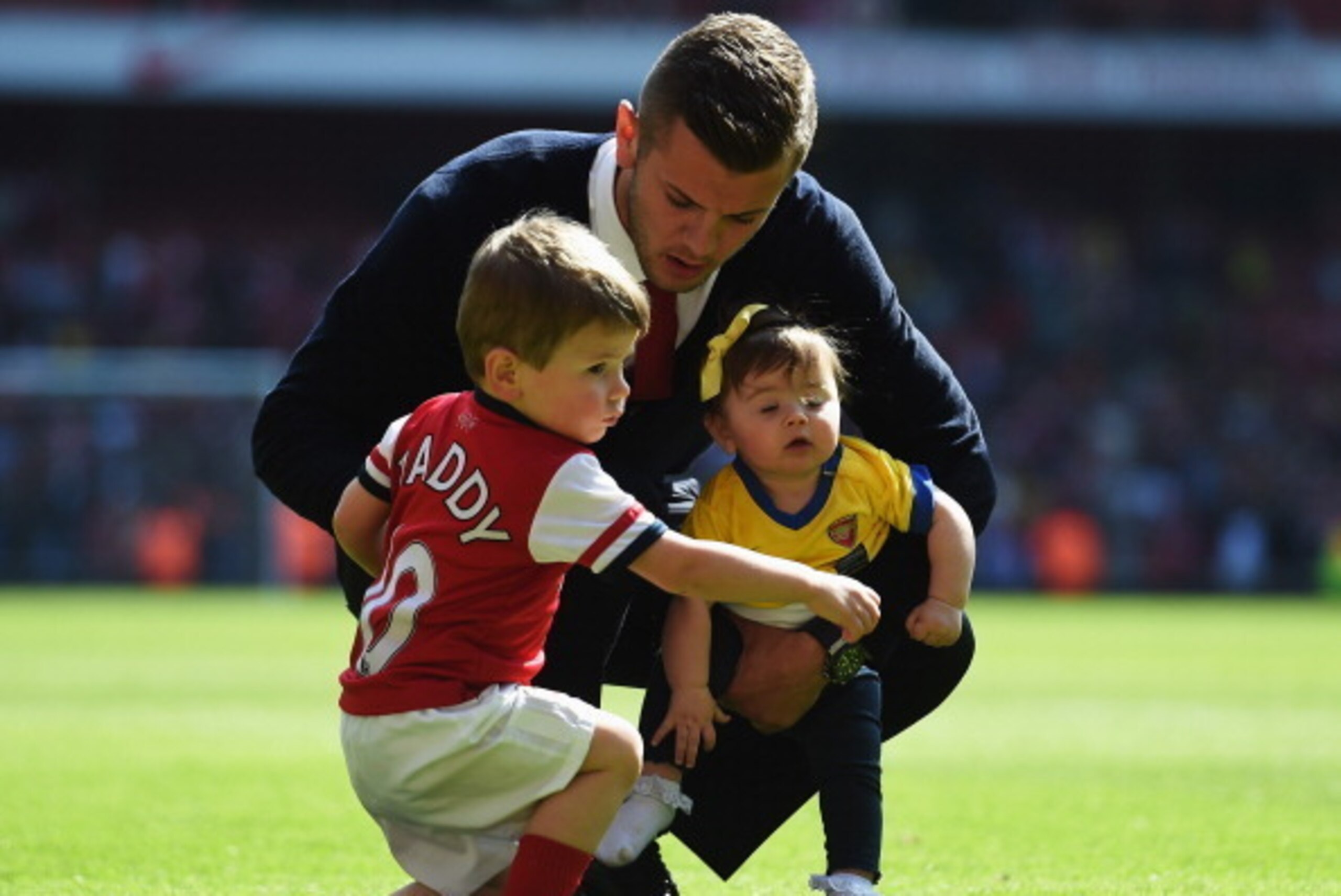 LONDON, ENGLAND - MAY 04:  Jack Wilshere of Arsenal with his daughter Delilah and son Archie on the pitch following the Barclays Premier League match between Arsenal and West Bromwich Albion at the Emirates Stadium on May 4, 2014 in London, England.  (Pho