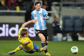 STOCKHOLM, SWEDEN - FEBRUARY 06:  Ramus Elm of Sweden battles with Lionel Messi of Argentina during the International Friendly match between Sweden and Argentina at the Friends Arena on February 6, 2013 in Stockholm, Sweden.  (Photo by Jamie McDonald/Gett