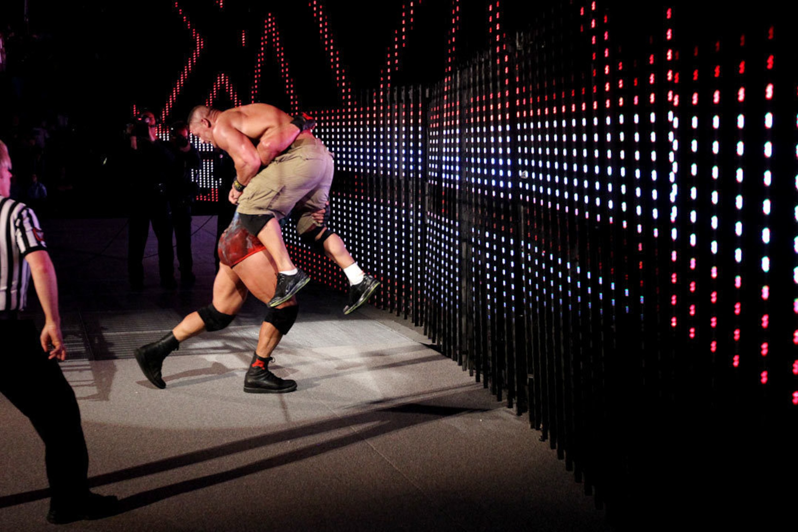 Ryback sends Cena crashing through the set.