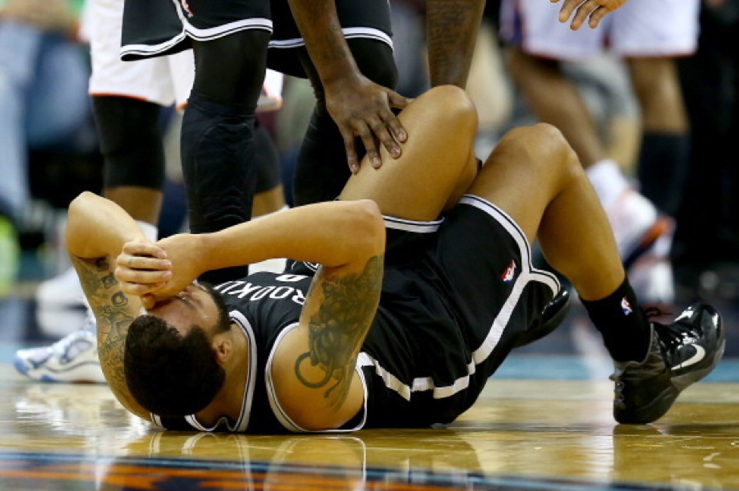 CHARLOTTE, NC - NOVEMBER 20:  Deron Williams #8 of the Brooklyn Nets reacts after an injury in the first half during their game against the Charlotte Bobcats at Time Warner Cable Arena on November 20, 2013 in Charlotte, North Carolina.  NOTE TO USER: User