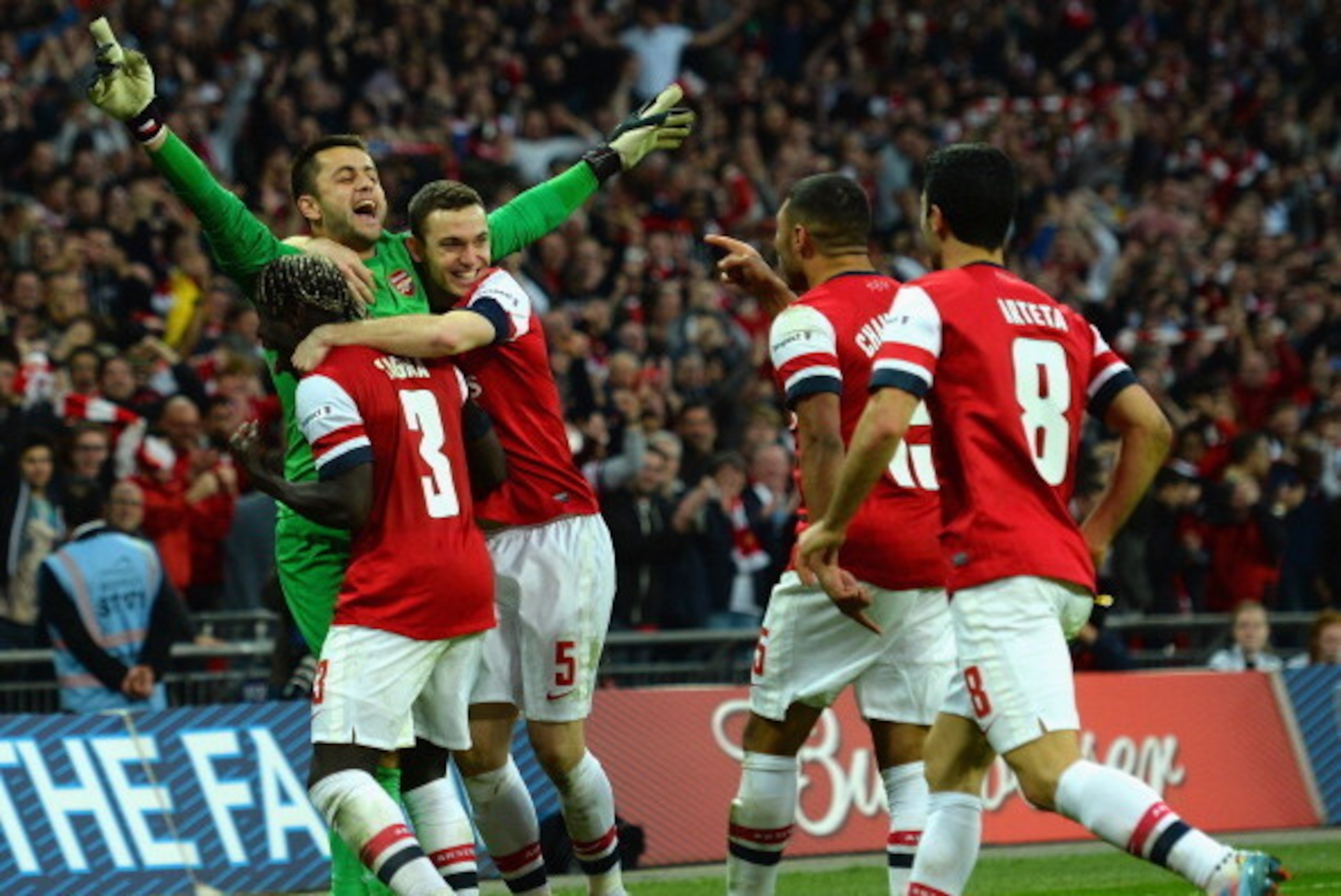 LONDON, ENGLAND - APRIL 12:  Lukasz Fabianski of Arsenal celebrates winning the penalty shoot out with team mates during the FA Cup Semi-Final match between Wigan Athletic and Arsenal at Wembley Stadium on April 12, 2014 in London, England.  (Photo by Sha