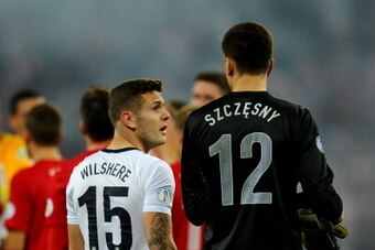 LONDON, ENGLAND - OCTOBER 15:  Jack Wilshere of England talks to Wojciech Szczesny of Poland as they qualify for the World Cup in Brazil after the FIFA 2014 World Cup Qualifying Group H match between England and Poland at Wembley Stadium on October 15, 20