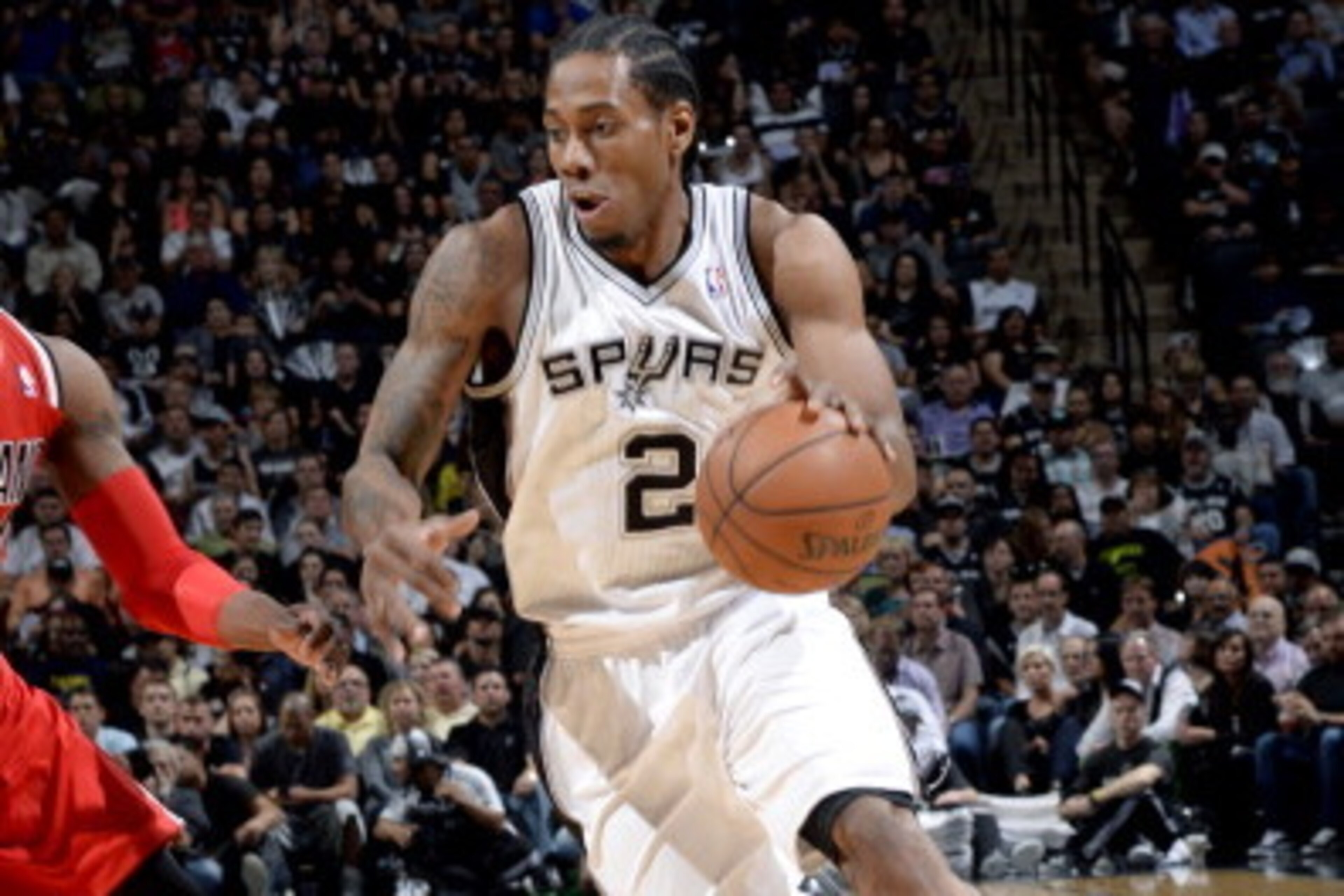SAN ANTONIO, TX - MAY 14: Kawhi Leonard #2 of the San Antonio Spurs drives against the Portland Trail Blazers in Game Five of the Western Conference Semifinals between the San Antonio Spurs and the Portland Trail Blazers during the 2014 NBA Playoffs on Ma SAN ANTONIO, TX - MAY 14: Kawhi Leonard #2 of the San Antonio Spurs drives against the Portland Trail Blazers in Game Five of the Western Conference Semifinals between the San Antonio Spurs and the Portland Trail Blazers during the 2014 NBA Playoffs on Ma