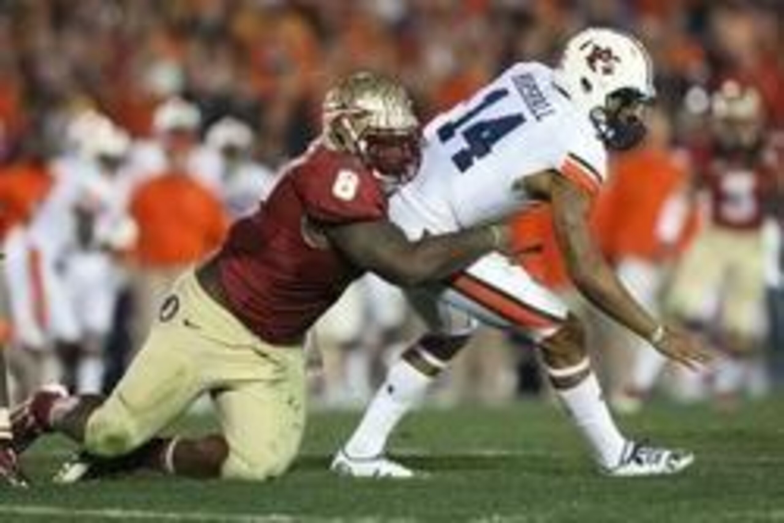 Jan 6, 2014; Pasadena, CA, USA; Auburn Tigers quarterback Nick Marshall (14) is tackled by Florida State Seminoles defensive tackle Timmy Jernigan (8) during the second half of the 2014 BCS National Championship game at the Rose Bowl. Mandatory Credit: Ma Jan 6, 2014; Pasadena, CA, USA; Auburn Tigers quarterback Nick Marshall (14) is tackled by Florida State Seminoles defensive tackle Timmy Jernigan (8) during the second half of the 2014 BCS National Championship game at the Rose Bowl. Mandatory Credit: Ma