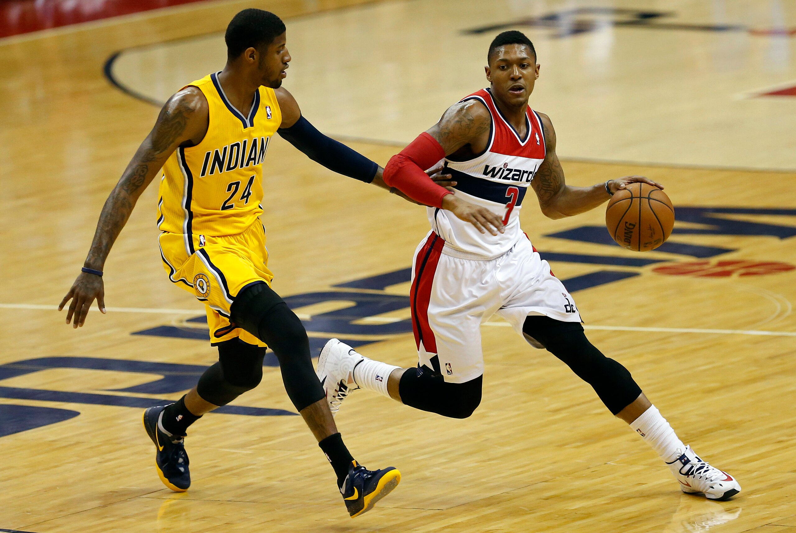 May 15, 2014; Washington, DC, USA; Washington Wizards guard Bradley Beal (3) dribbles the ball as Indiana Pacers forward Paul George (24) defends in the first quarter in game six of the second round of the 2014 NBA Playoffs at Verizon Center. Mandatory Cr
