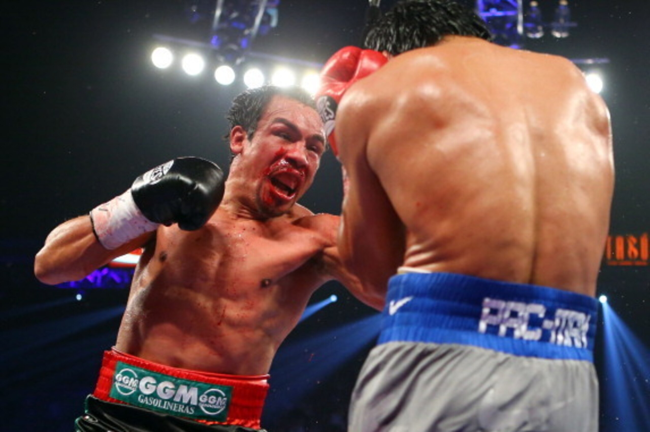 LAS VEGAS, NV - DECEMBER 08:  (L-R) Juan Manuel Marquez throws a left at Manny Pacquiao during their welterweight bout at the MGM Grand Garden Arena on December 8, 2012 in Las Vegas, Nevada.  (Photo by Al Bello/Getty Images)