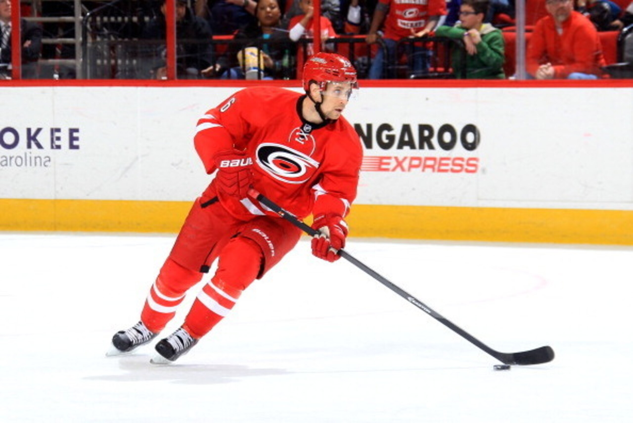 RALEIGH, NC - MARCH 25: John-Michael Liles #26 of the Carolina Hurricanes carries the puck during their NHL game against the New York Islanders at PNC Arena on March 25, 2014 in Raleigh, North Carolina.  (Photo by Gregg Forwerck/NHLI via Getty Images)