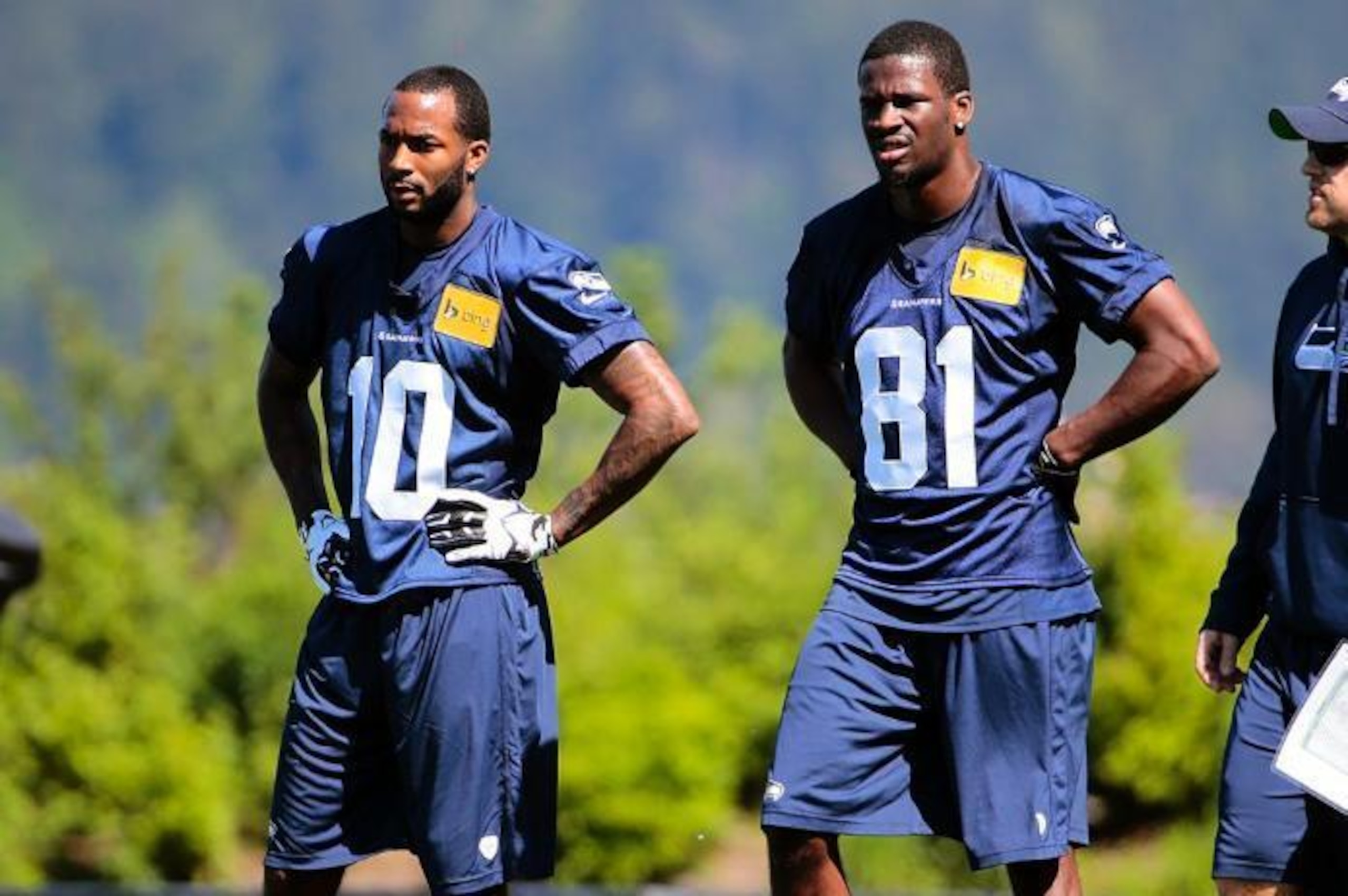 Paul Richardson (left) and Kevin Norwood (right) watch a drill at Seattle's three-day rookie minicamp.