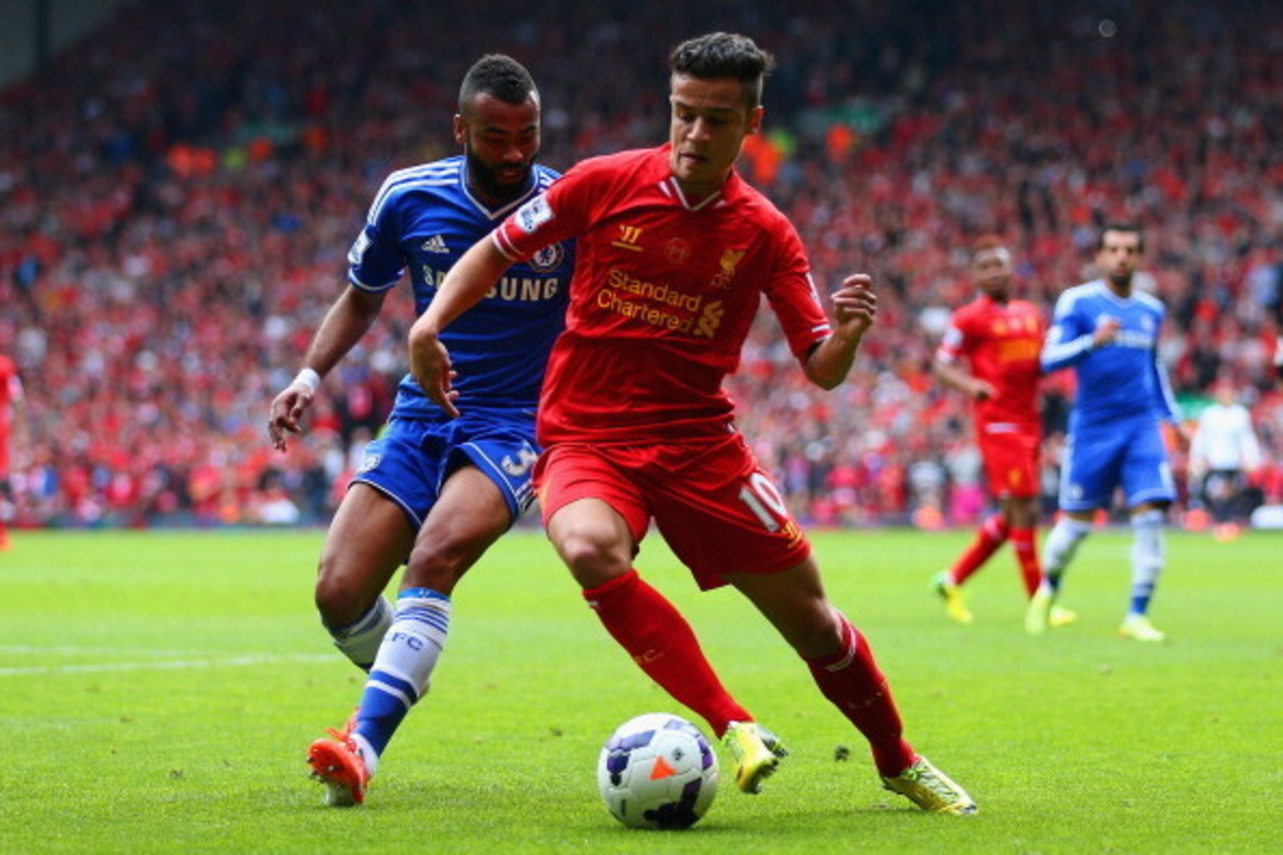 LIVERPOOL, ENGLAND - APRIL 27: Ashley Cole of Chelsea and Philippe Coutinho of Liverpool compete for the ball during the Barclays Premier League match between Liverpool and Chelsea at Anfield on April 27, 2014 in Liverpool, England.  (Photo by Clive Bruns