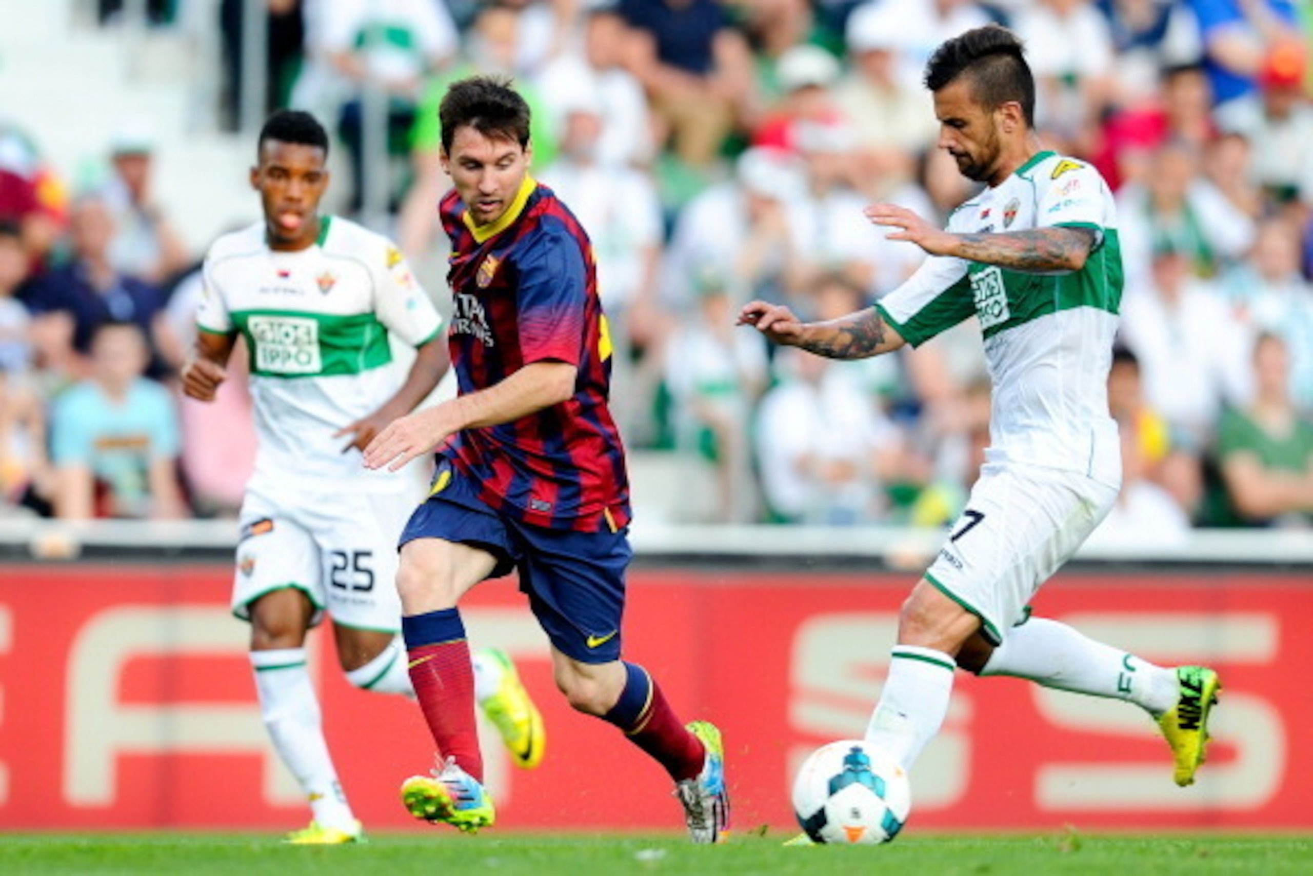 ELCHE, SPAIN - MAY 11:  Lionel Messi of FC Barcelona competes for the ball with Javi Marquez (R) of Elche FC during the La Liga match between Elche FC and FC Barcelona at Estadio Manuel Martinez Valero on May 11, 2014 in Elche, Spain.  (Photo by David Ram