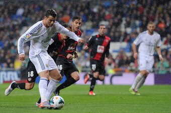 MADRID, SPAIN - MARCH 29:  Cristiano Ronaldo of Real Madrid FC scores his team's opening goal during the La Liga match between Real Madrid CF and Rayo Vallecano de Madrid at Santiago Bernabeu stadium on March 29, 2014 in Madrid, Spain.  (Photo by Denis Do