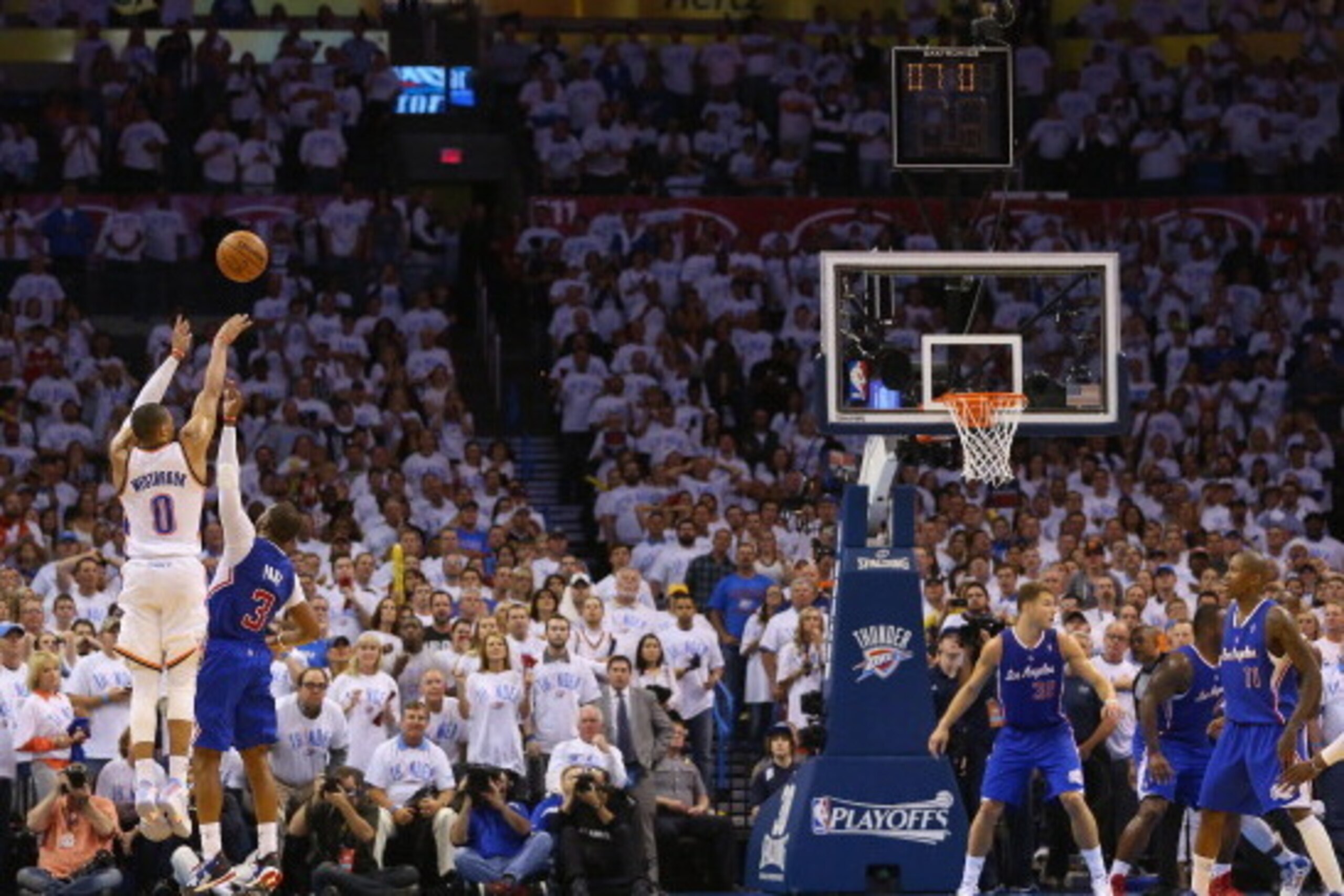 OKLAHOMA CITY, OK - MAY 13: Russell Westbrook #0 of the Oklahoma City Thunder is fouled on a three-point attempt by Chris Paul #3 of the Los Angeles Clippers in Game Five of the Western Conference Semifinals during the 2014 NBA Playoffs at Chesapeake Ene OKLAHOMA CITY, OK - MAY 13: Russell Westbrook #0 of the Oklahoma City Thunder is fouled on a three-point attempt by Chris Paul #3 of the Los Angeles Clippers in Game Five of the Western Conference Semifinals during the 2014 NBA Playoffs at Chesapeake Ene