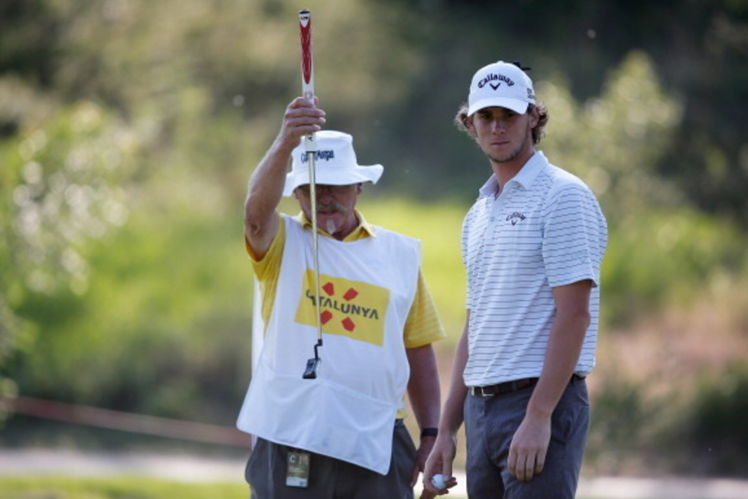 GIRONA, SPAIN - MAY 16:  Thomas Pieters (R) of Belgium and his caddie line up a putt on the 9th green during Day 2 of the Open de Espana held at PGA Catalunya Resort on May 16, 2014 in Girona, Spain.  (Photo by Dean Mouhtaropoulos/Getty Images)