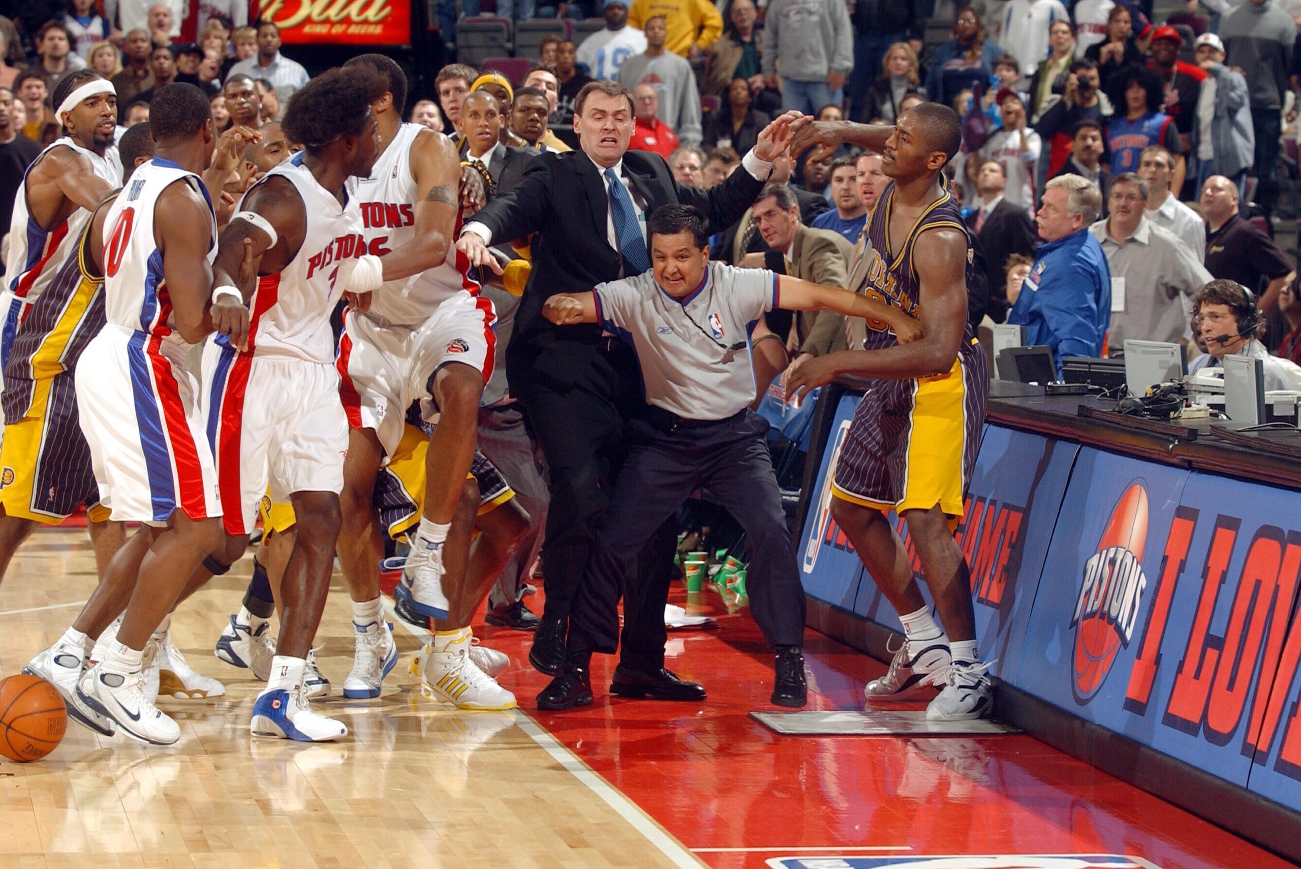AUBURN HILLS, MI - NOVEMBER 19:  Ben Wallace #3 of the Detroit Pistons and teammates are kept apart from Ron Artest #91 of the Indiana Pacers by Pacers head coach Rick Carlisle and official Tommy Nunez Jr. on November 19, 2004 during their game at the Pal