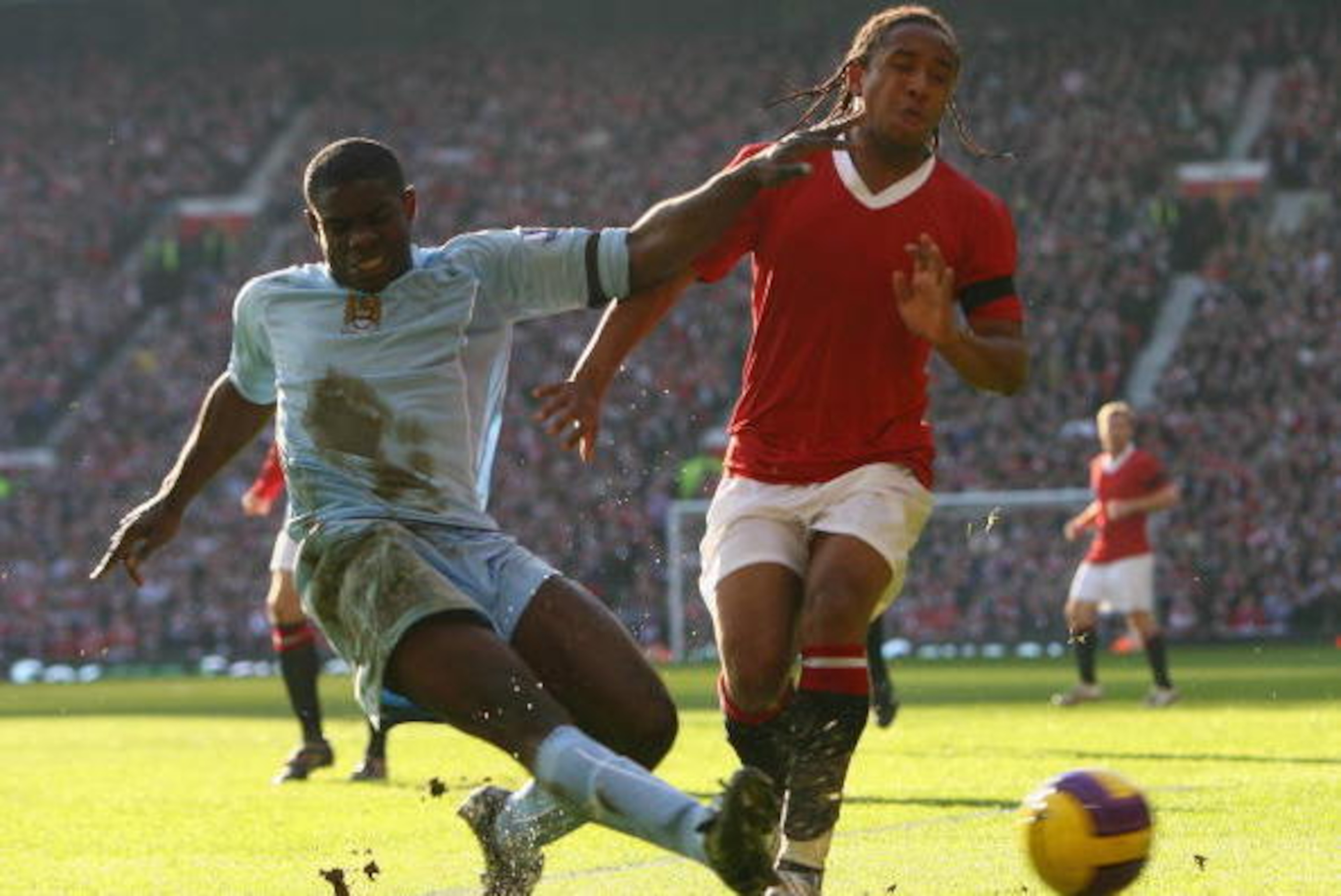 MANCHESTER, UNITED KINGDOM - FEBRUARY 10: Micah Richards of Manchester City tackles Anderson of Manchester United during the Barclays Premier League match between Manchester United and Manchester City at Old Trafford on February 10, 2008 in Manchester, E MANCHESTER, UNITED KINGDOM - FEBRUARY 10: Micah Richards of Manchester City tackles Anderson of Manchester United during the Barclays Premier League match between Manchester United and Manchester City at Old Trafford on February 10, 2008 in Manchester, E