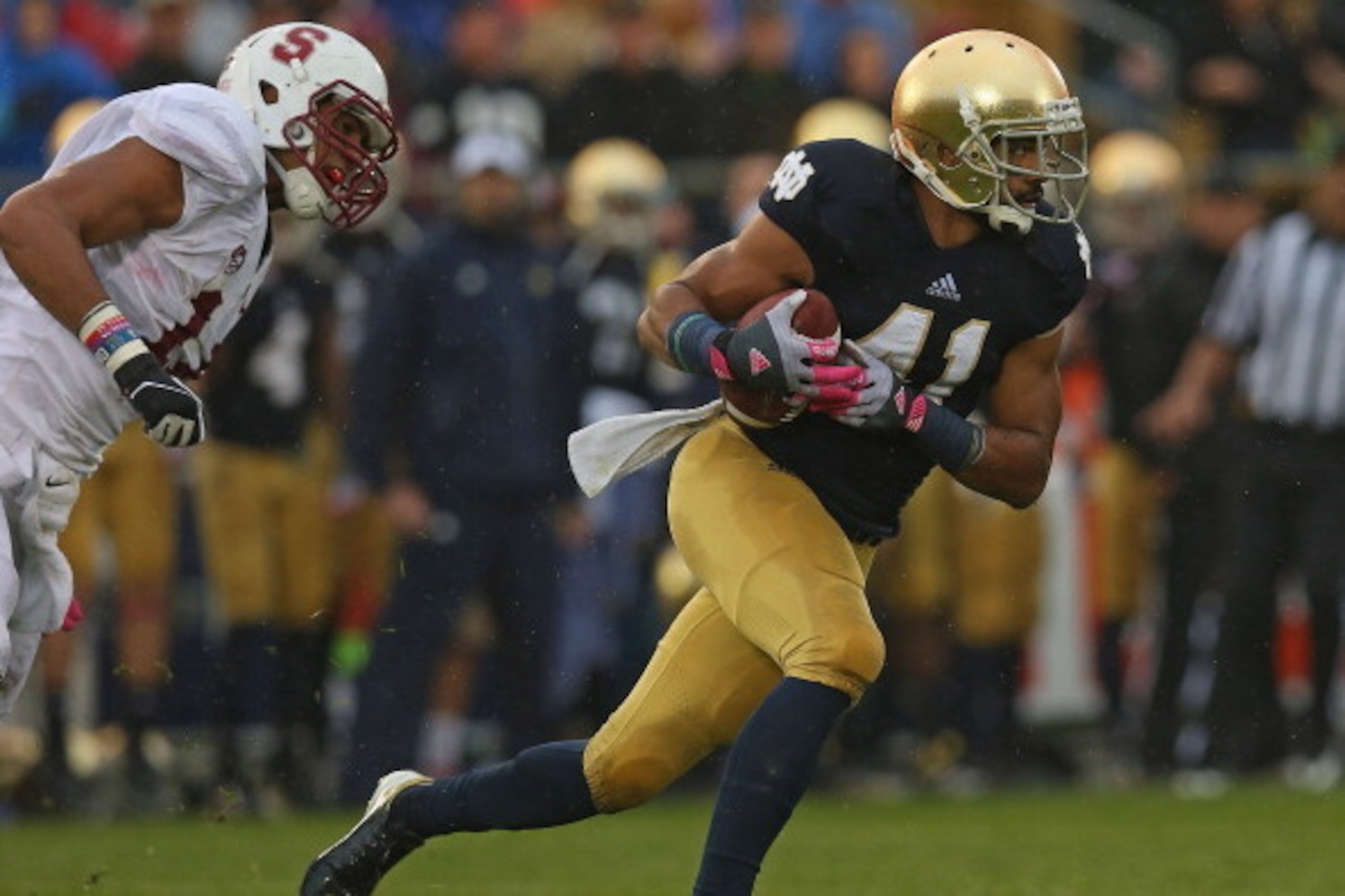 SOUTH BEND, IN - OCTOBER 13:  Matthias Farley #41 of the Notre Dame Fighting Irish breaks away from Levine Toilolo#11 of the Standford Cardinal after intercepting a pass at Notre Dame Stadium on October 13, 2012 in South Bend, Indiana. Notre Dame defeated