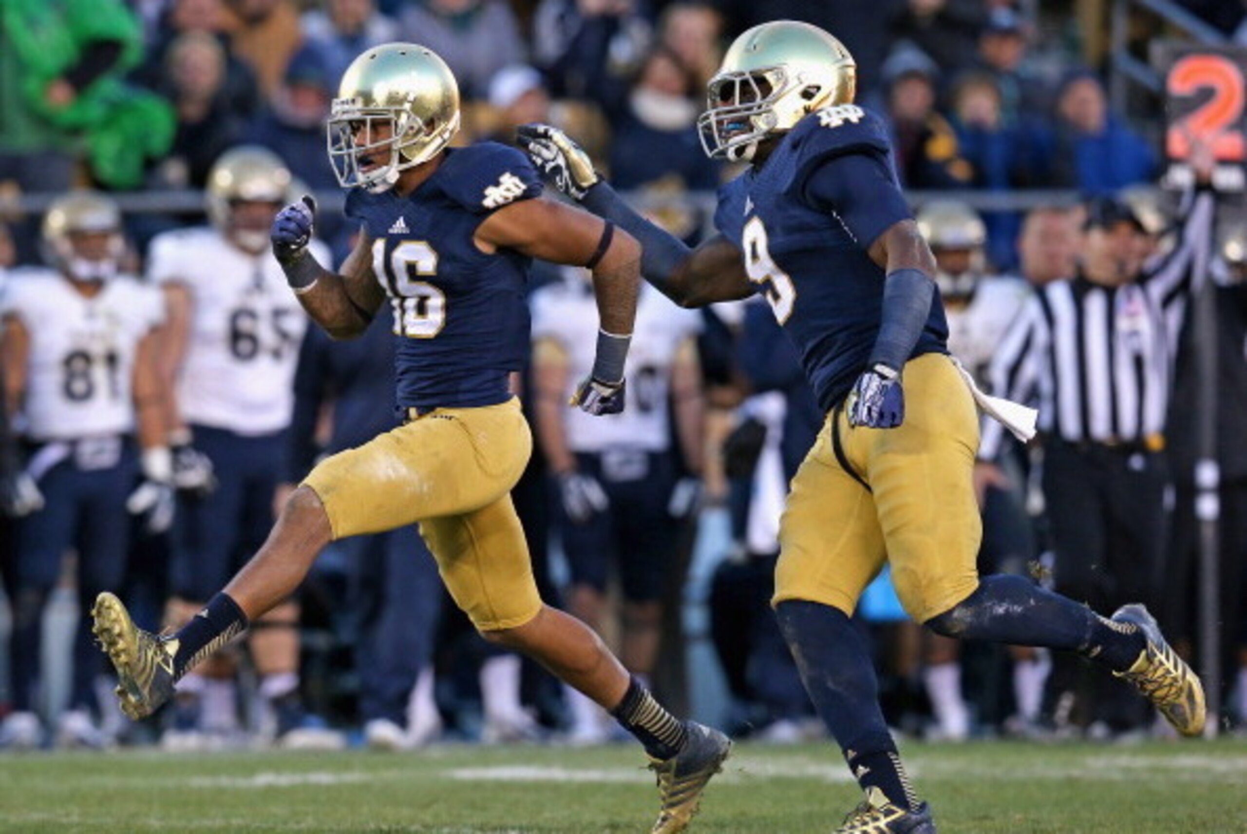 SOUTH BEND, IN - NOVEMBER 02:  Eilar Hardy #16 (L) and Jaylon Smith #9 of the Notre Dame Fighting Irish celebrate a sack against the Navy Midshipmen at Notre Dame Stadium on November 2, 2013 in South Bend, Indiana. Notre Dame defeated Navy 38-34.  (Photo 