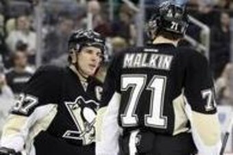 Feb 7, 2014; Pittsburgh, PA, USA;  Pittsburgh Penguins center Sidney Crosby (87) talks to center Evgeni Malkin (71) during a time-out against the New York Rangers in the second period at the CONSOL Energy Center. The Rangers won 4-3 in a shootout. Mandato