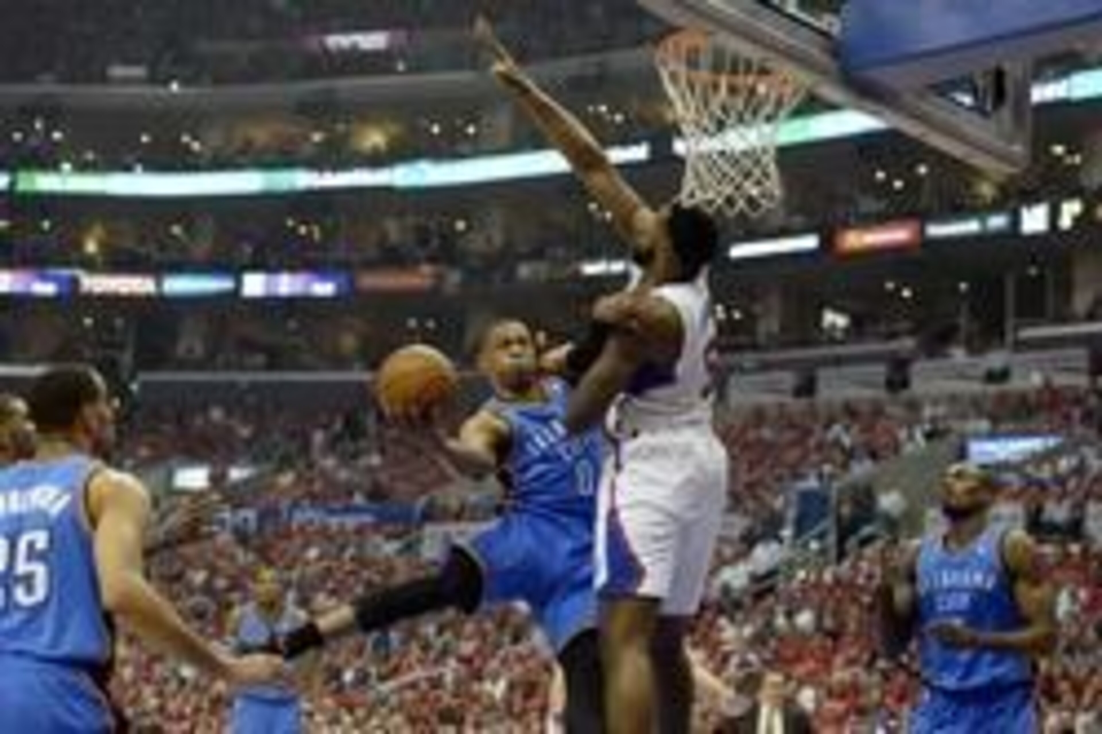 May 15, 2014; Los Angeles, CA, USA; Oklahoma City Thunder guard Russell Westbrook (0) shoots against Los Angeles Clippers center DeAndre Jordan (6) during the first quarter in game six of the second round of the 2014 NBA Playoffs at Staples Center. Mandat