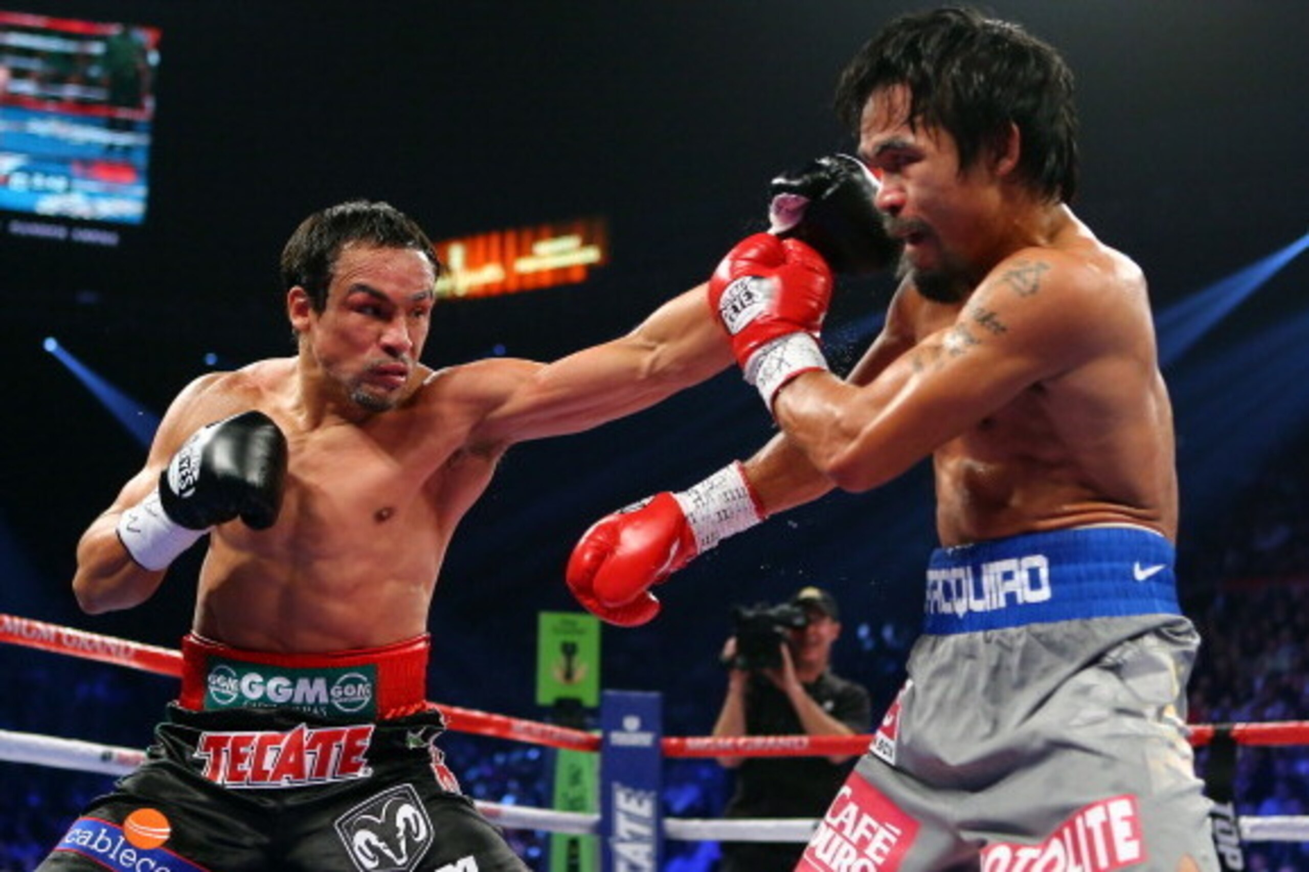 LAS VEGAS, NV - DECEMBER 08:  (L-R) Juan Manuel Marquez throws a left to the face of Manny Pacquiao during their welterweight bout at the MGM Grand Garden Arena on December 8, 2012 in Las Vegas, Nevada.  (Photo by Al Bello/Getty Images)