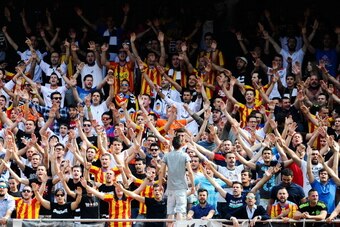 VALENCIA, SPAIN - APRIL 27:  Valencia CF supporters cheer on their team during the La Liga match between Valencia CF and Club Atletico de Madrid at Estadio Mestalla on April 27, 2014 in Valencia, Spain.  (Photo by David Ramos/Getty Images)