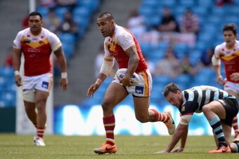 MANCHESTER, ENGLAND - MAY 17:  Jeff Lima of Catalan Dragons gets past Nick Slyney of London Broncos during the Super League match between London Broncos and Catalan Dragons at Etihad Stadium on May 17, 2014 in Manchester, England.  (Photo by Gareth Copley