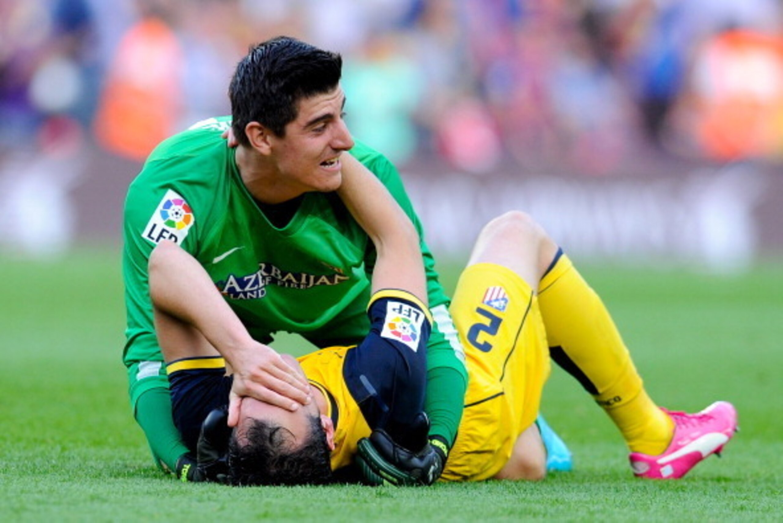 BARCELONA, SPAIN - MAY 17:  Thibaut Courtois of Atletico de Madrid celebrates with his teammate Diego Godin of Atletico de Madrid at the end of the La Liga match between FC Barcelona and Club Atletico de Madrid at Camp Nou on May 17, 2014 in Barcelona, Sp