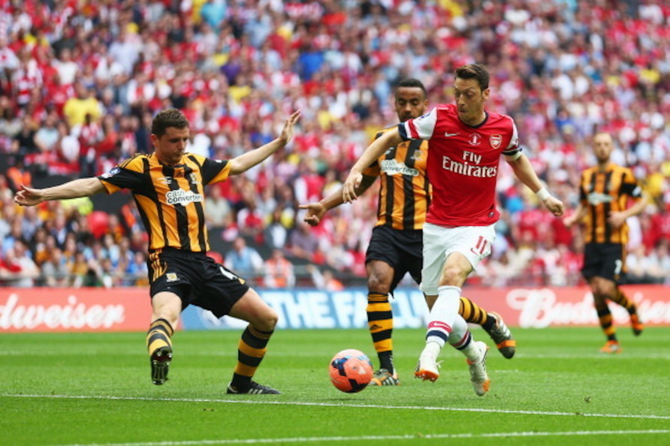 LONDON, ENGLAND - MAY 17: Mesut Oezil of Arsenal takes on Alex Bruce of Hull City during the FA Cup with Budweiser Final match between Arsenal and Hull City at Wembley Stadium on May 17, 2014 in London, England. (Photo by Paul Gilham/Getty Images) LONDON, ENGLAND - MAY 17: Mesut Oezil of Arsenal takes on Alex Bruce of Hull City during the FA Cup with Budweiser Final match between Arsenal and Hull City at Wembley Stadium on May 17, 2014 in London, England. (Photo by Paul Gilham/Getty Images)