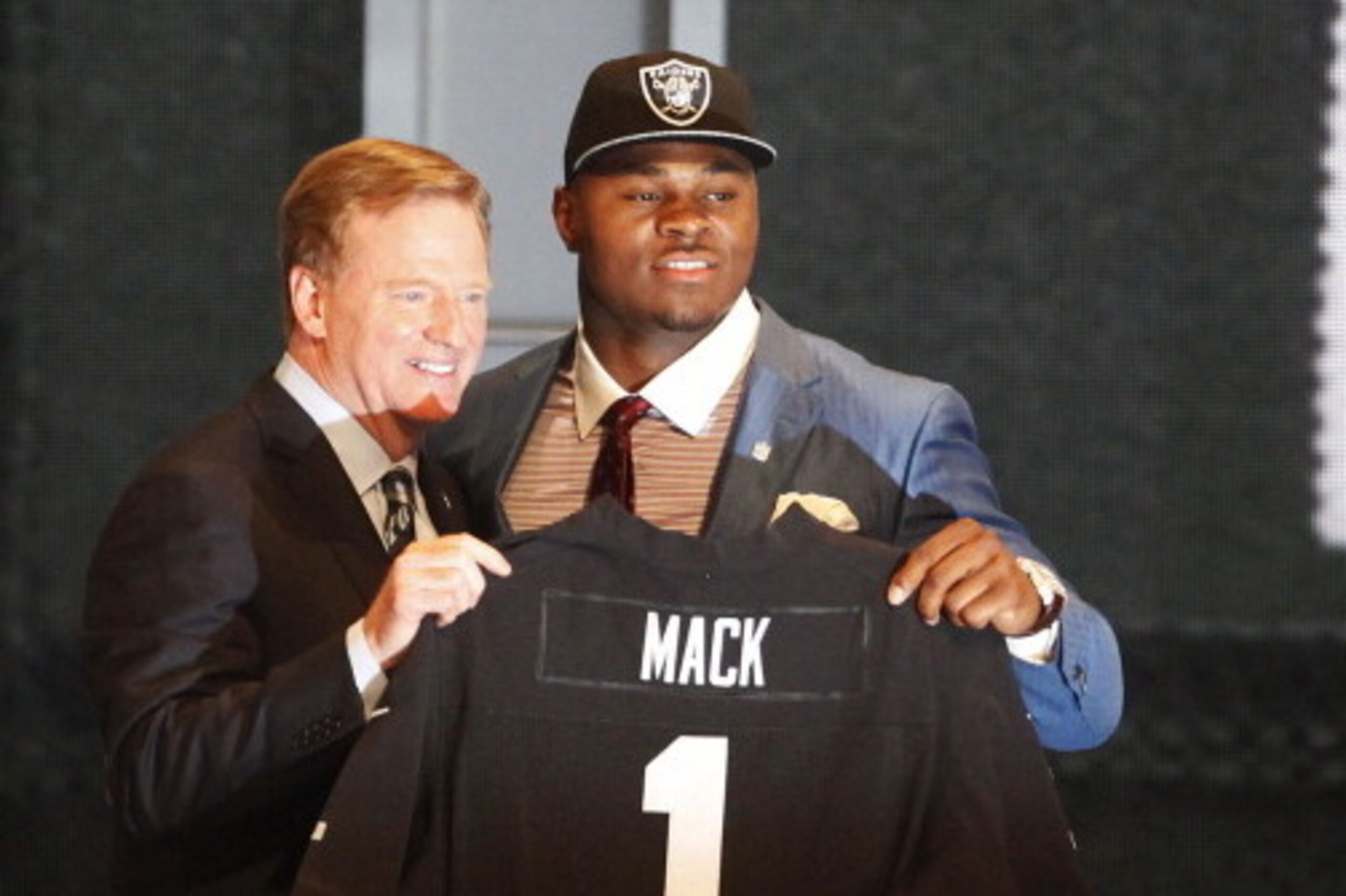 NEW YORK, NY - MAY 08:  Khalil Mack of the Buffalo Bulls poses with NFL Commissioner Roger Goodell after he was picked #5 overall by the Oakland Raiders during the first round of the 2014 NFL Draft at Radio City Music Hall on May 8, 2014 in New York City.
