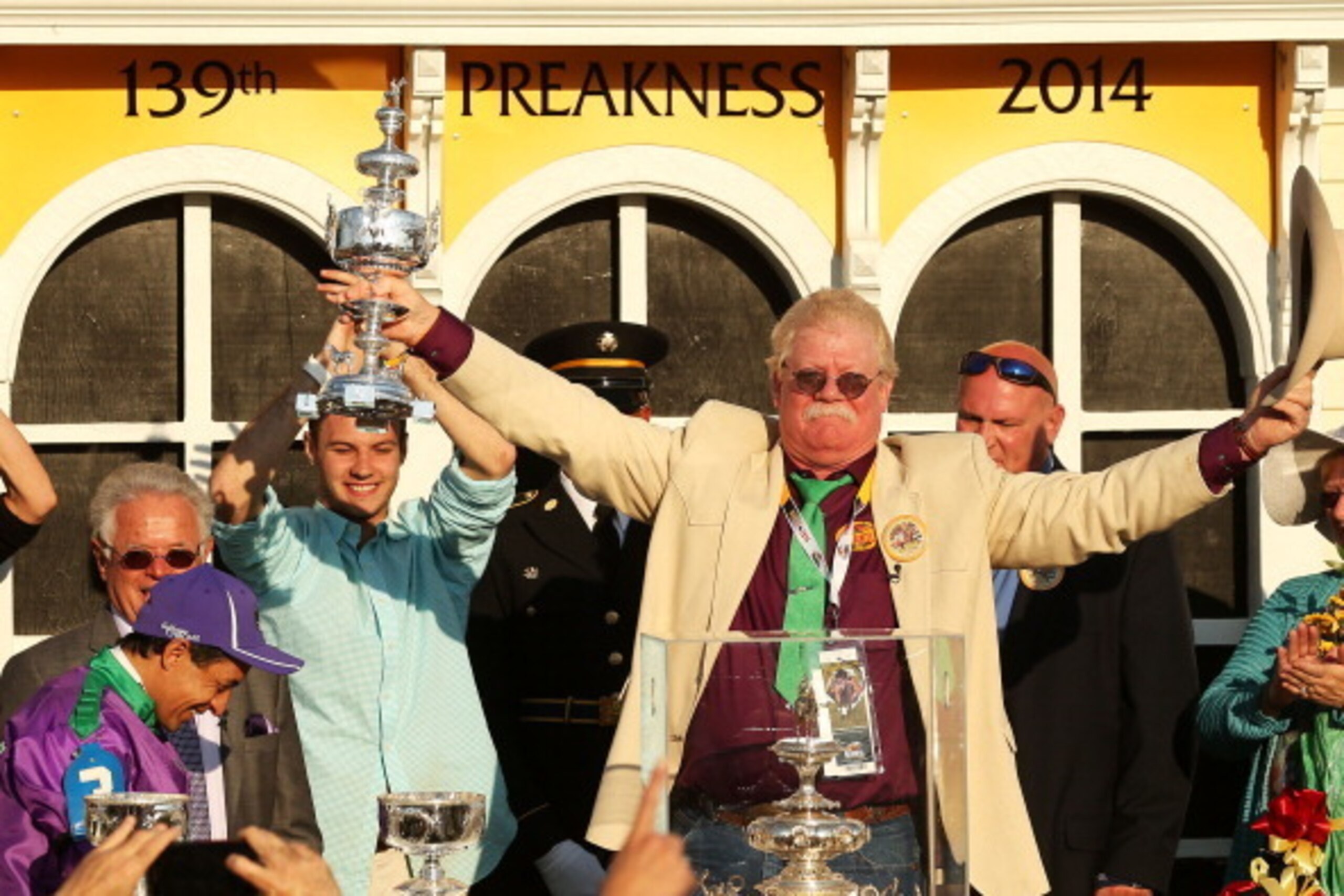 BALTIMORE, MD - MAY 17:  Owner of California Chrome Steve Coburn celebrates in the winner's circle with jockey Victor Espinoza after winning the 139th running of the Preakness Stakes at Pimlico Race Course on May 17, 2014 in Baltimore, Maryland.  (Photo b