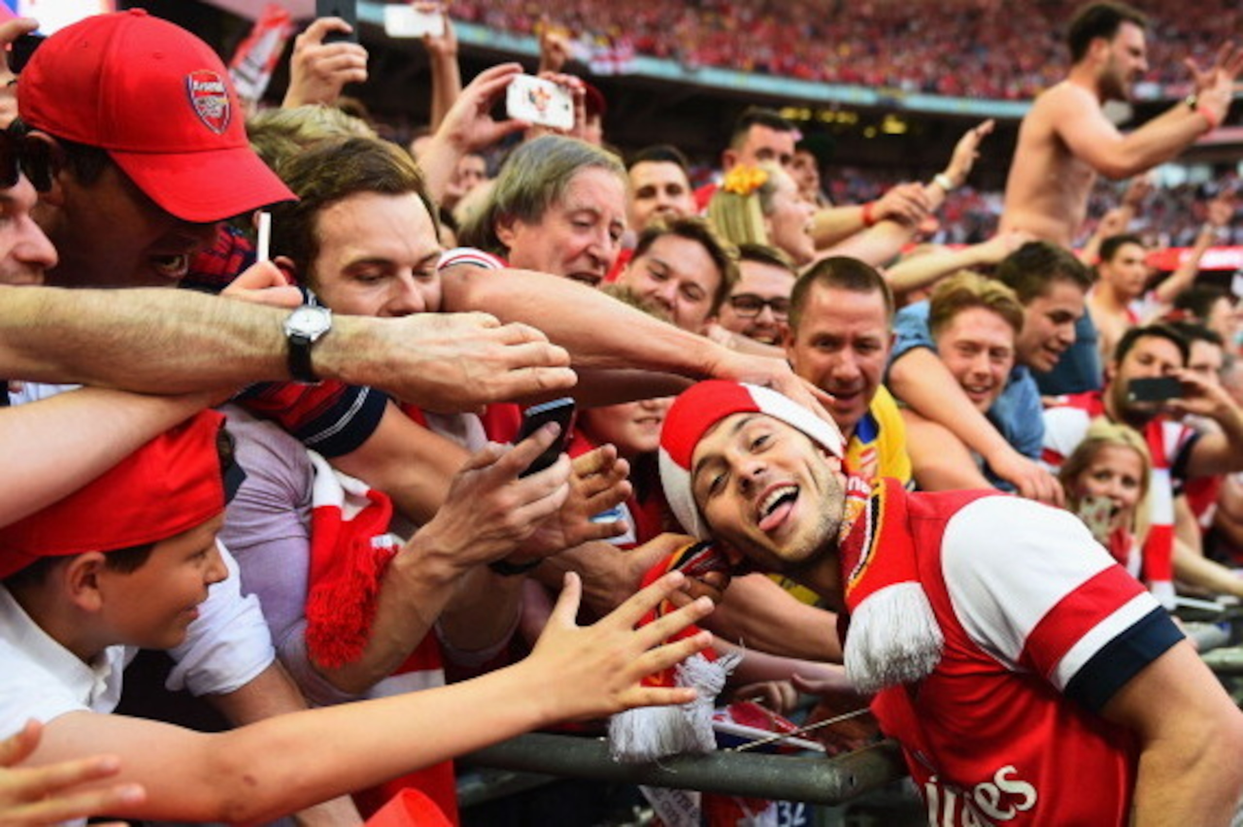 LONDON, ENGLAND - MAY 17:  Jack Wilshere of Arsenal celebrates victory with fans after the FA Cup with Budweiser Final match between Arsenal and Hull City at Wembley Stadium on May 17, 2014 in London, England.  (Photo by Shaun Botterill/Getty Images)