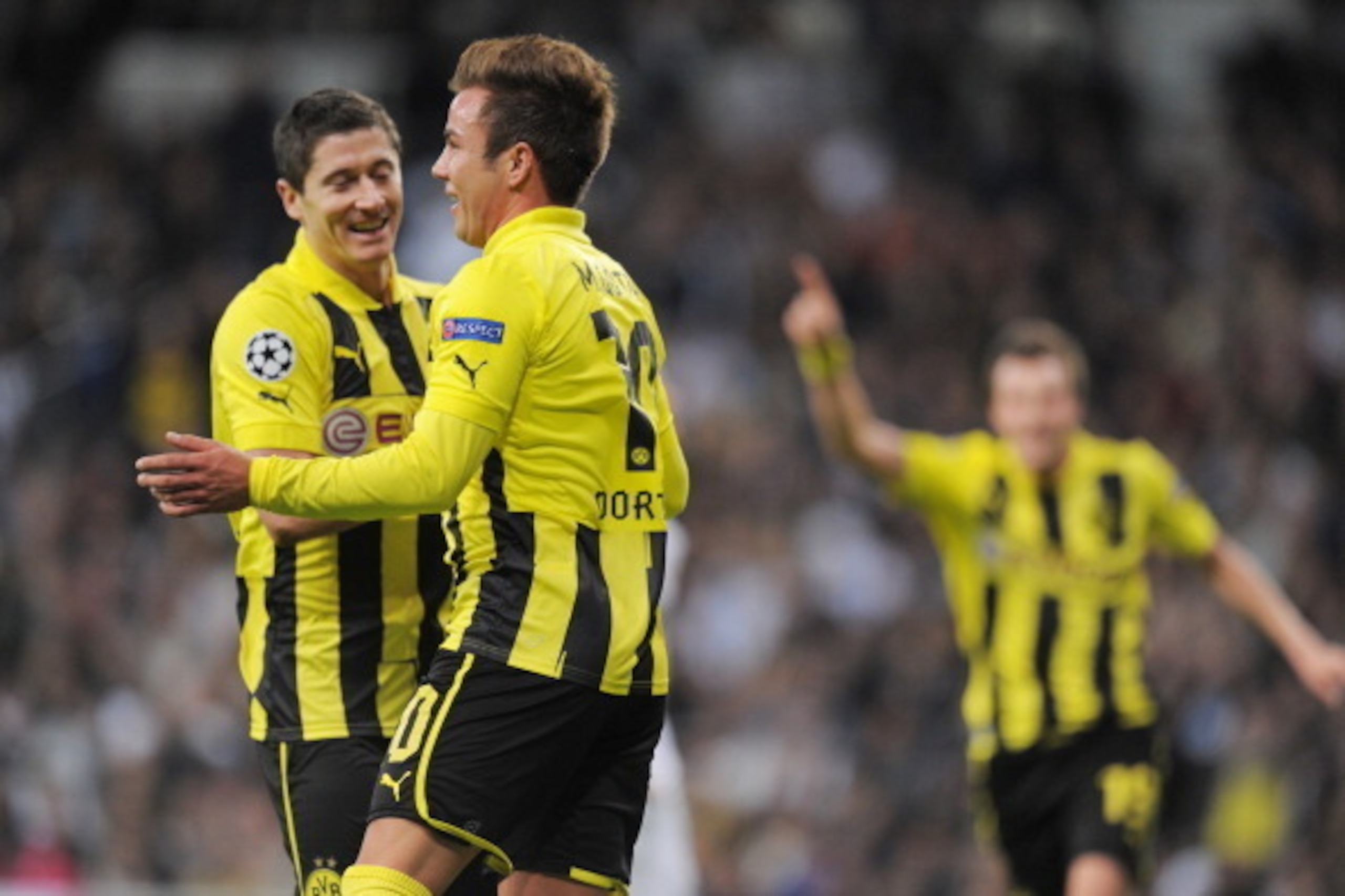 MADRID, SPAIN - NOVEMBER 06:  Mario Gotze (2nd L) of Borussia Dortmund celebrates with team-mate Robert Lewandowski after scoring their team's second goal during the UEFA Champions League Group D match between Real Madrid and Borussia Dortmund at Estadio