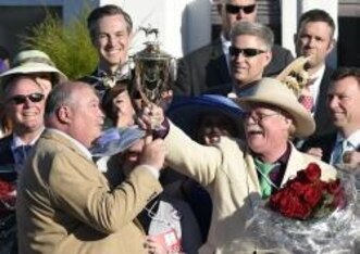 May 3, 2014; Louisville, KY, USA; California Chrome co-owners Steven Coburn (right) and Perry Martin (left) celebrate with the winner's trophy after the 2014 Kentucky Derby at Churchill Downs. Mandatory Credit: Richard Mackson-USA TODAY Sports