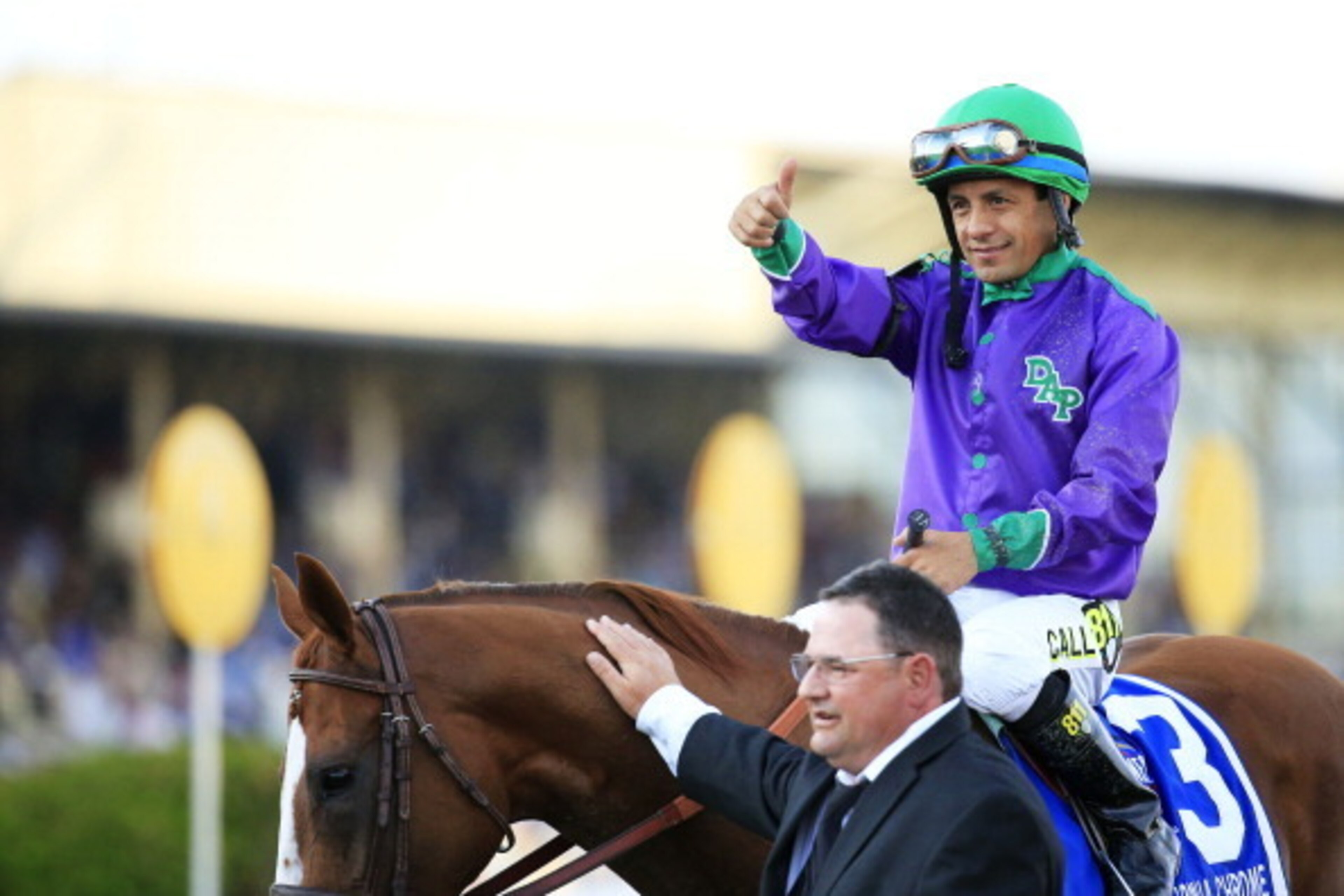 BALTIMORE, MD - MAY 17:  Victor Espinoza celebrates atop California Chrome #3 with assistant trainer Alan Sherman after winning the 139th running of the Preakness Stakes at Pimlico Race Course on May 17, 2014 in Baltimore, Maryland.  (Photo by Patrick Smi