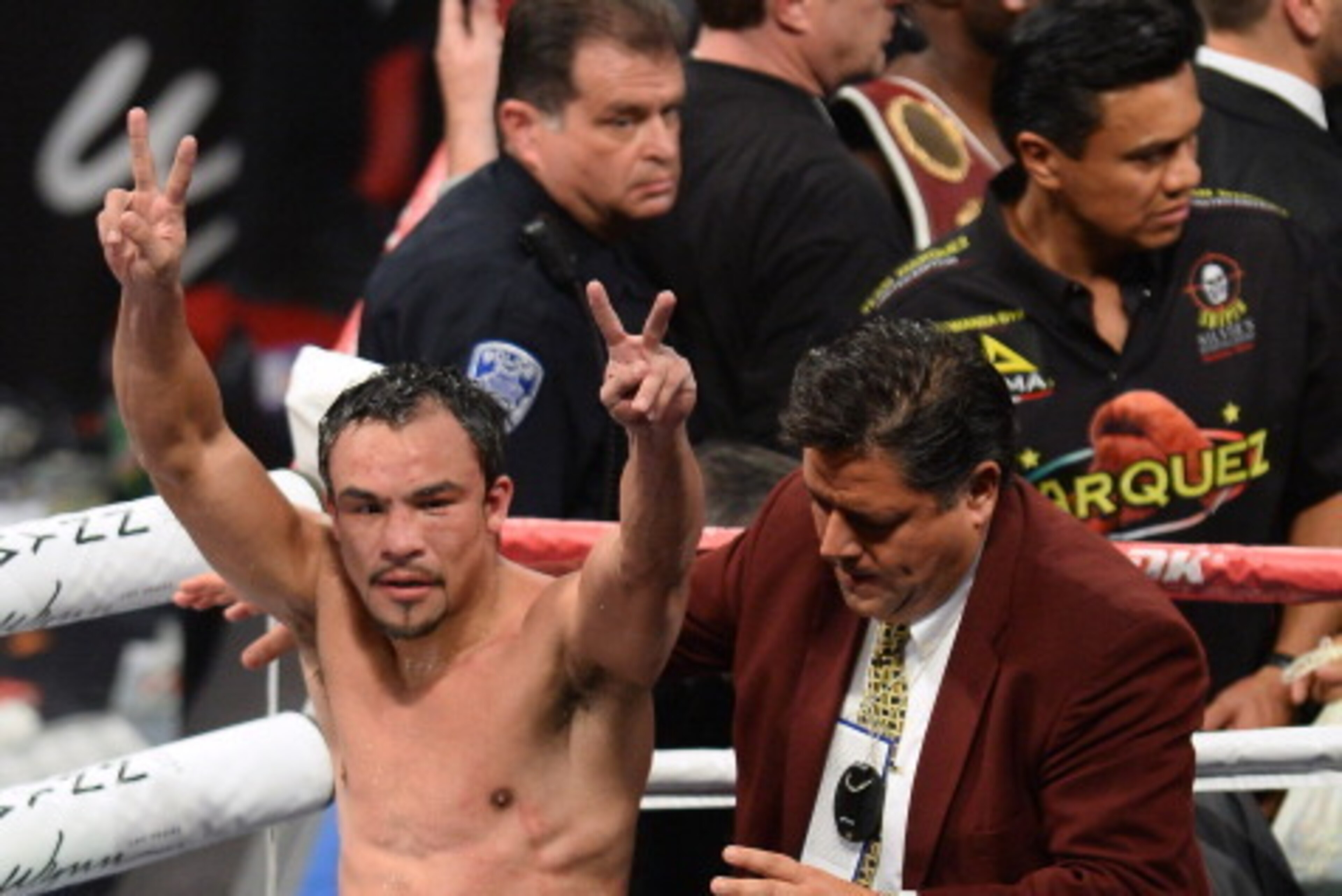 LAS VEGAS, NV - OCTOBER 12:  Juan Manuel Marquez raises his arms as he leaves the ring after his fight against WBO welterweight champion Timothy Bradley Jr. at the Thomas & Mack Center on October 12, 2013 in Las Vegas, Nevada. Bradley won in a split decis