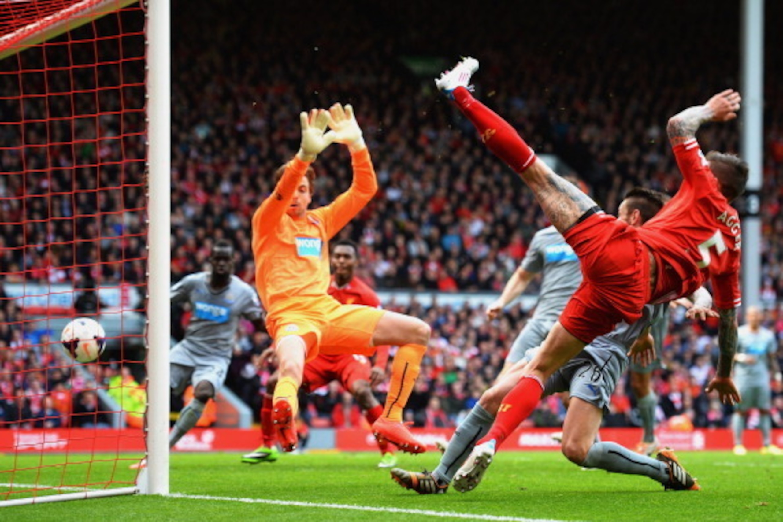LIVERPOOL, ENGLAND - MAY 11:  Daniel Agger of Liverpool (5) shoots past Tim Krul of Newcastle United to score their first goal during the Barclays Premier League match between Liverpool and Newcastle United at Anfield on May 11, 2014 in Liverpool, England