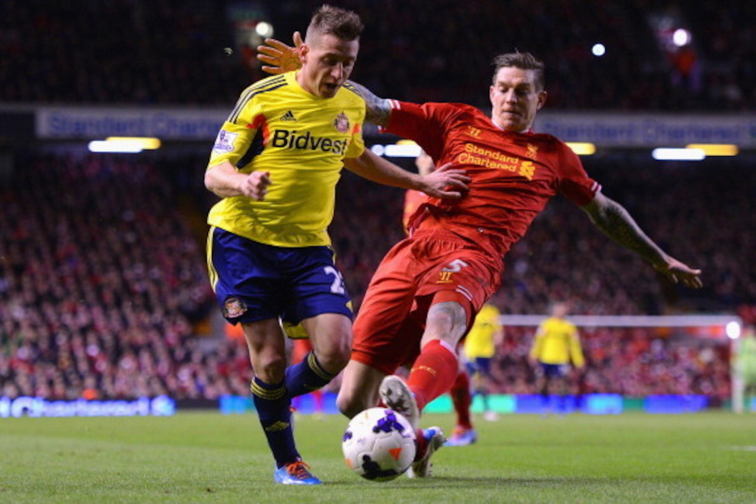 LIVERPOOL, ENGLAND - MARCH 26:  Daniel Agger of Liverpool challenges Emanuele Giaccherini of Sunderland during the Barclays Premier League match between Liverpool and Sunderland at Anfield on March 26, 2014 in Liverpool, England.  (Photo by Michael Regan/