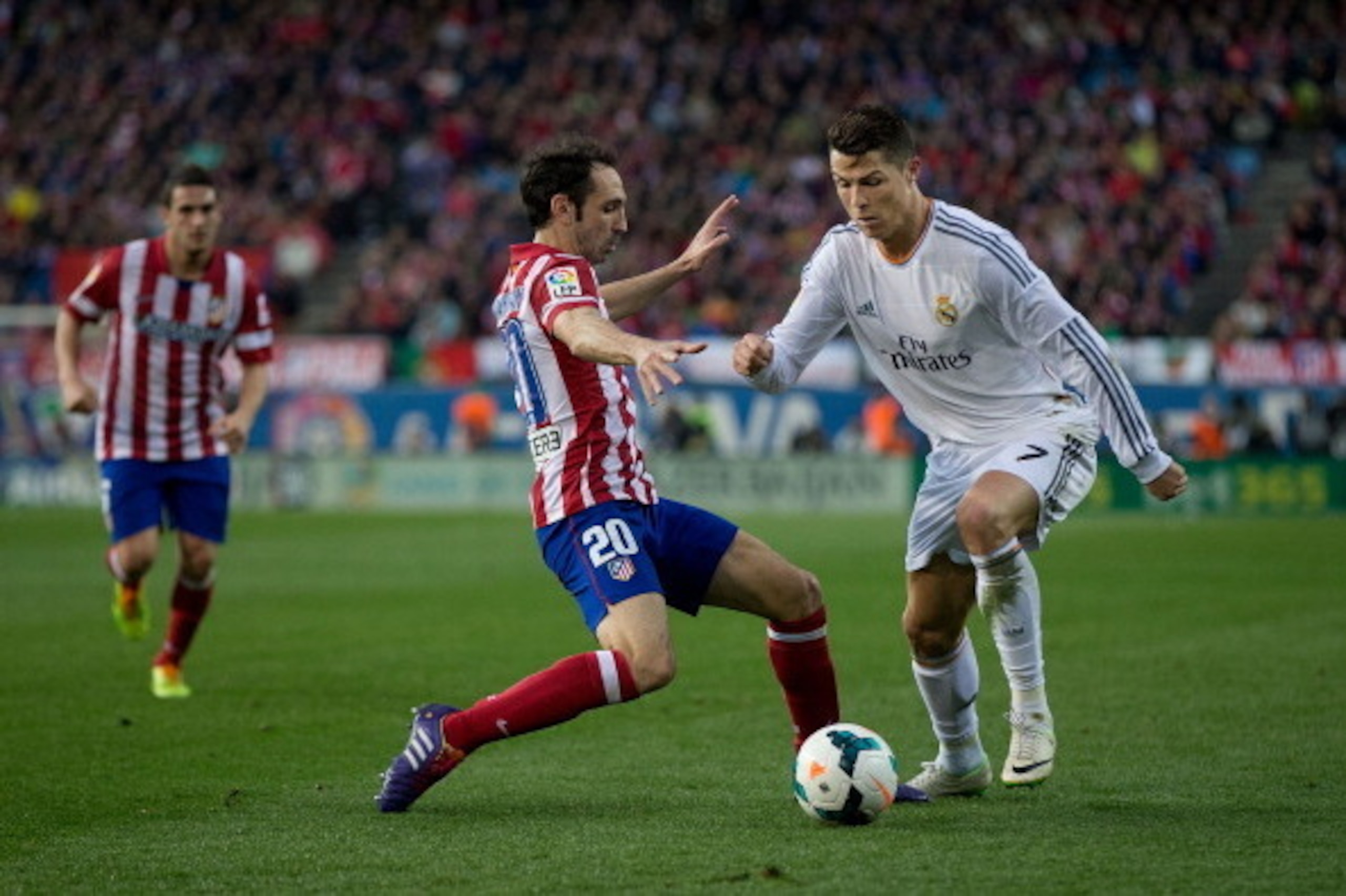 MADRID, SPAIN - MARCH 02: Cristiano Ronaldo (R) of Real Madrid CF competes for the ball with Juan Francisco Torres alias Juanfran (L) of Atletico de Madrid during the La Liga match between Club Atletico de Madrid and Real Madrid CF at Vicente Calderon Sta
